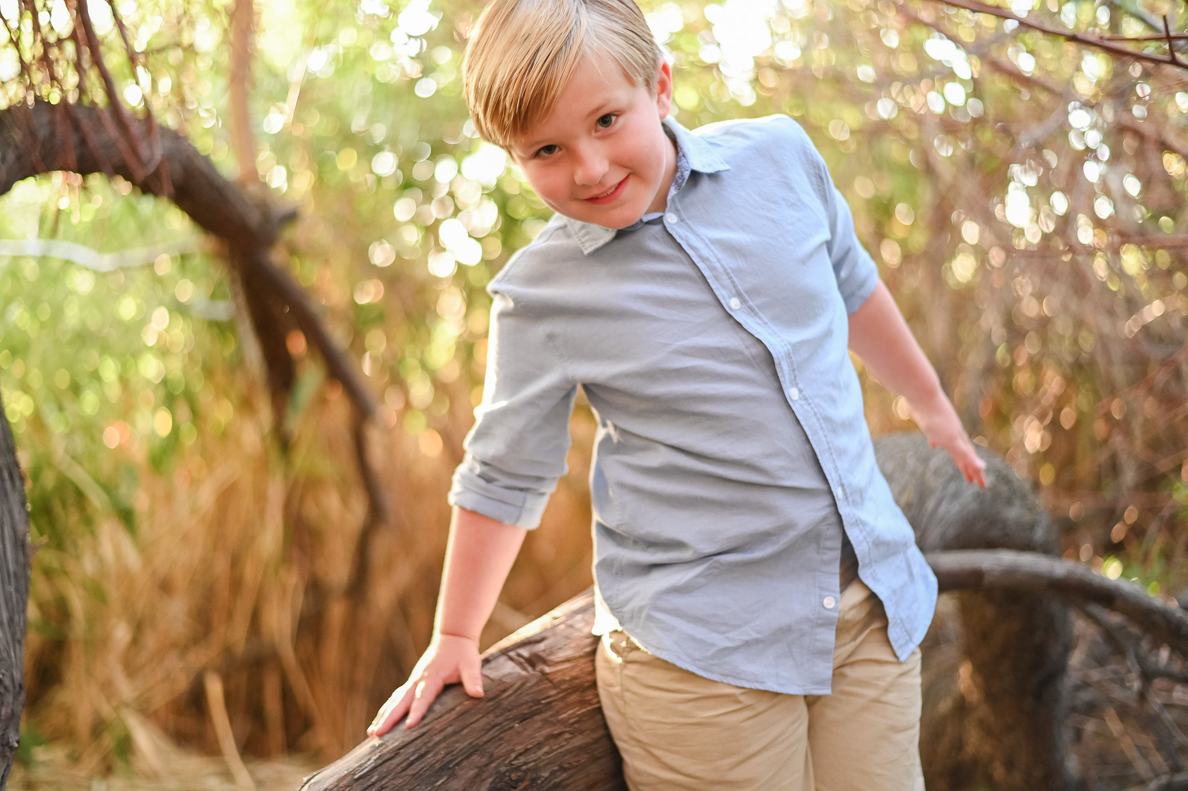Little boy smiling on at Tunnel Springs Park at golden hour.