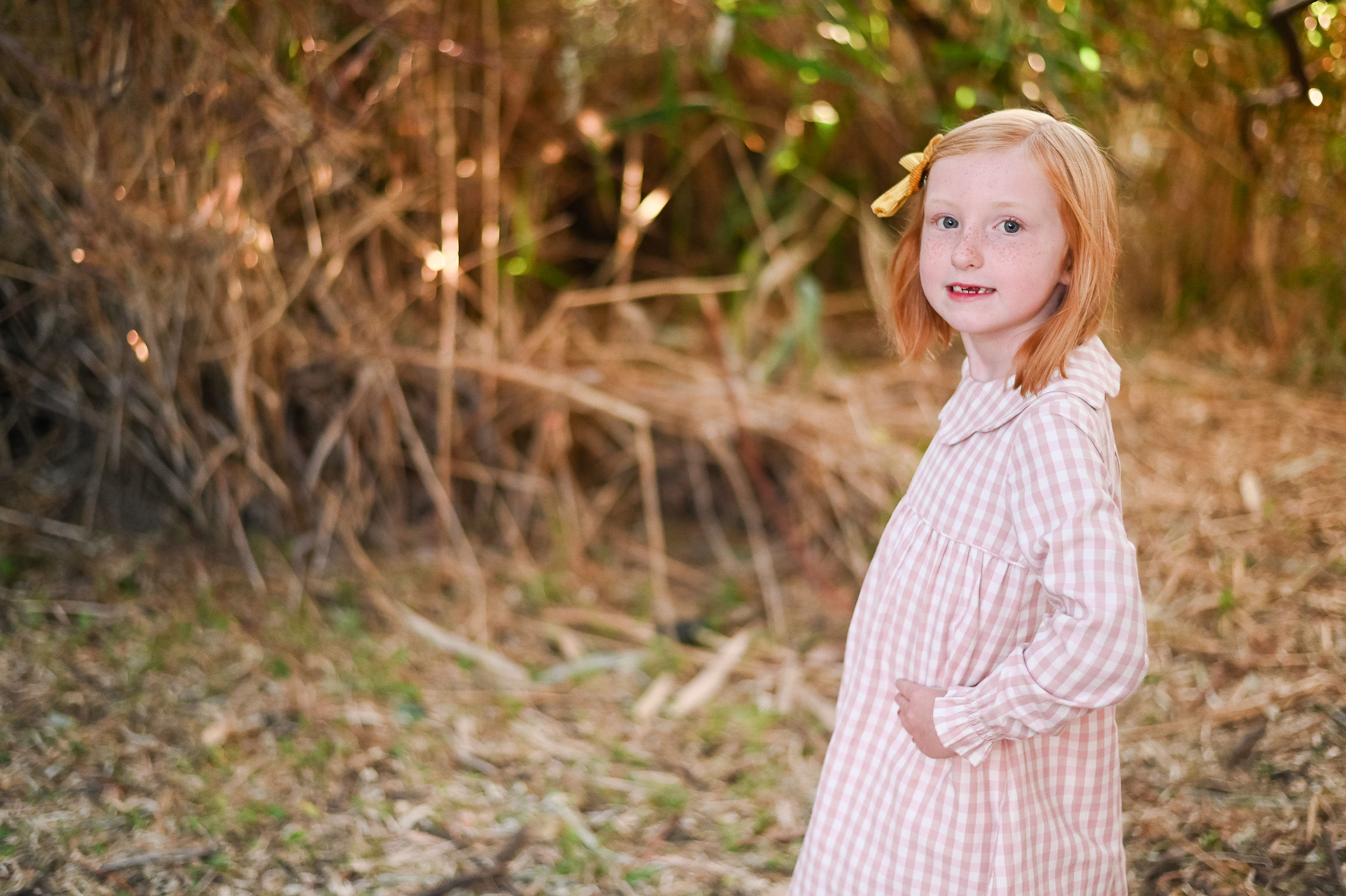Little girl smiling golden hour of Tunnel Springs Park in Utah.