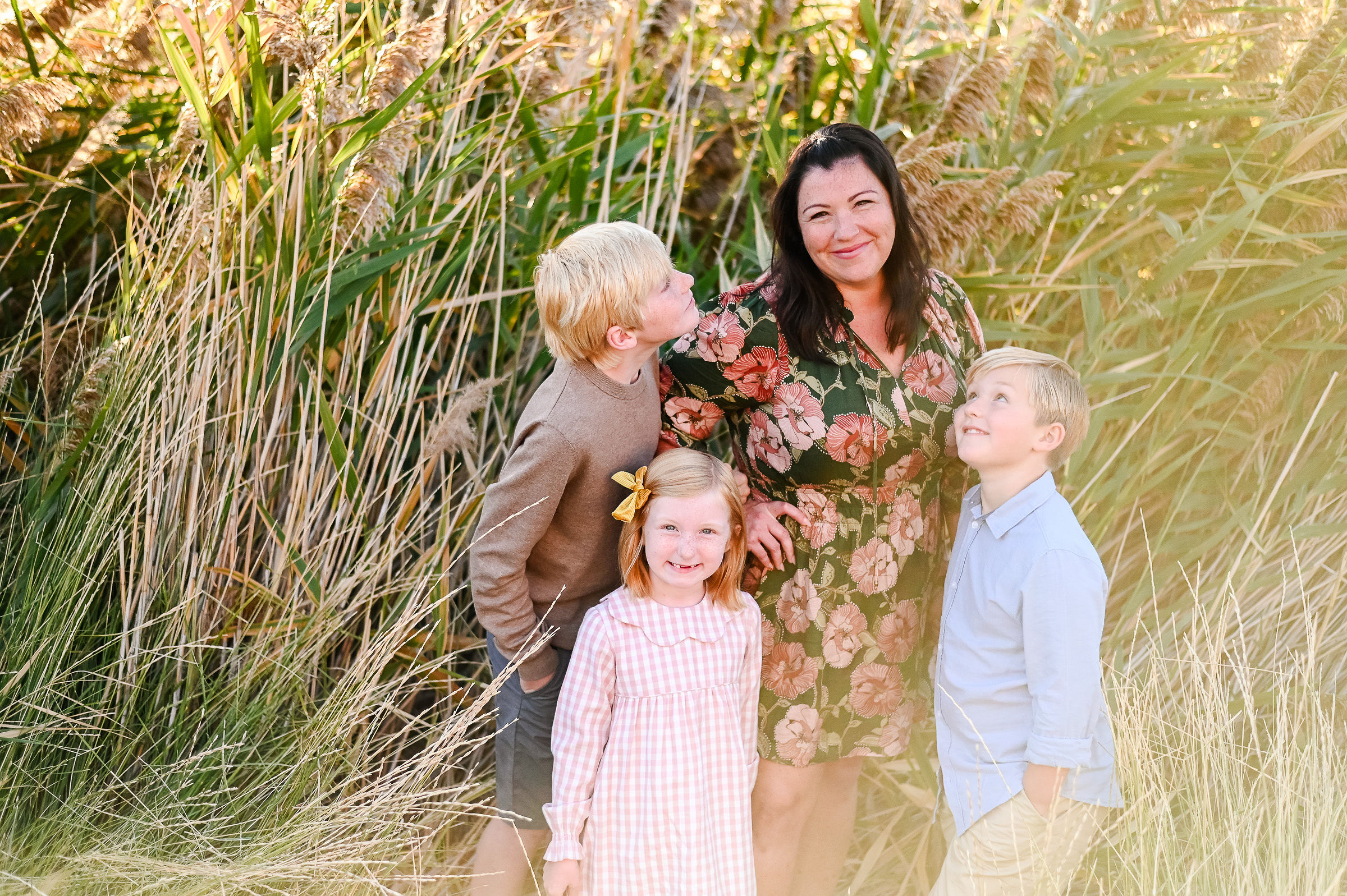 Kids adoring their Mom at Tunnel Springs Park in Utah during golden hour.
