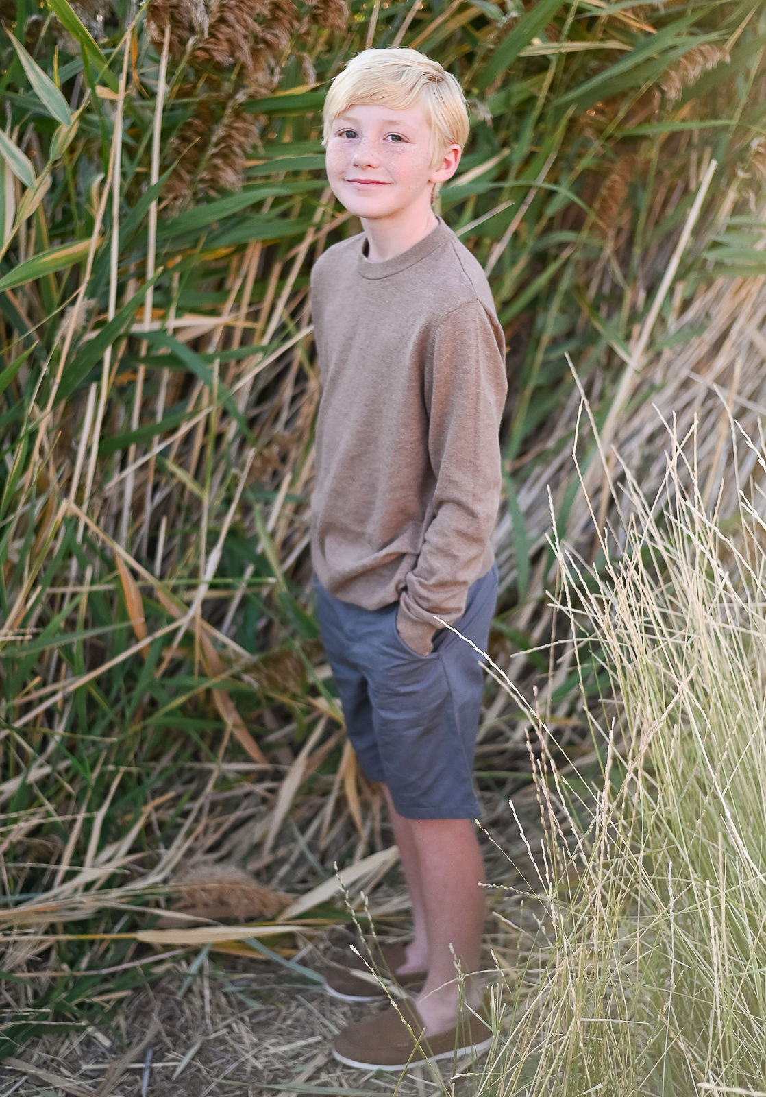 Little boy smiling on at golden hour in Tunnel Springs Park.