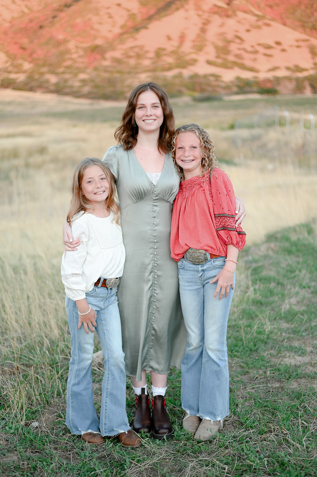 Sisters hold onto one another in the foothills of the mountains in Mapleton Utah.