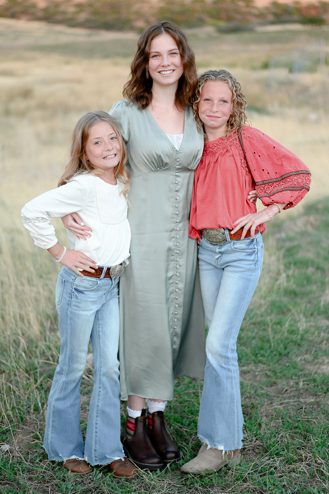Sisters hold onto one another in the foothills of the mountains in Mapleton Utah.