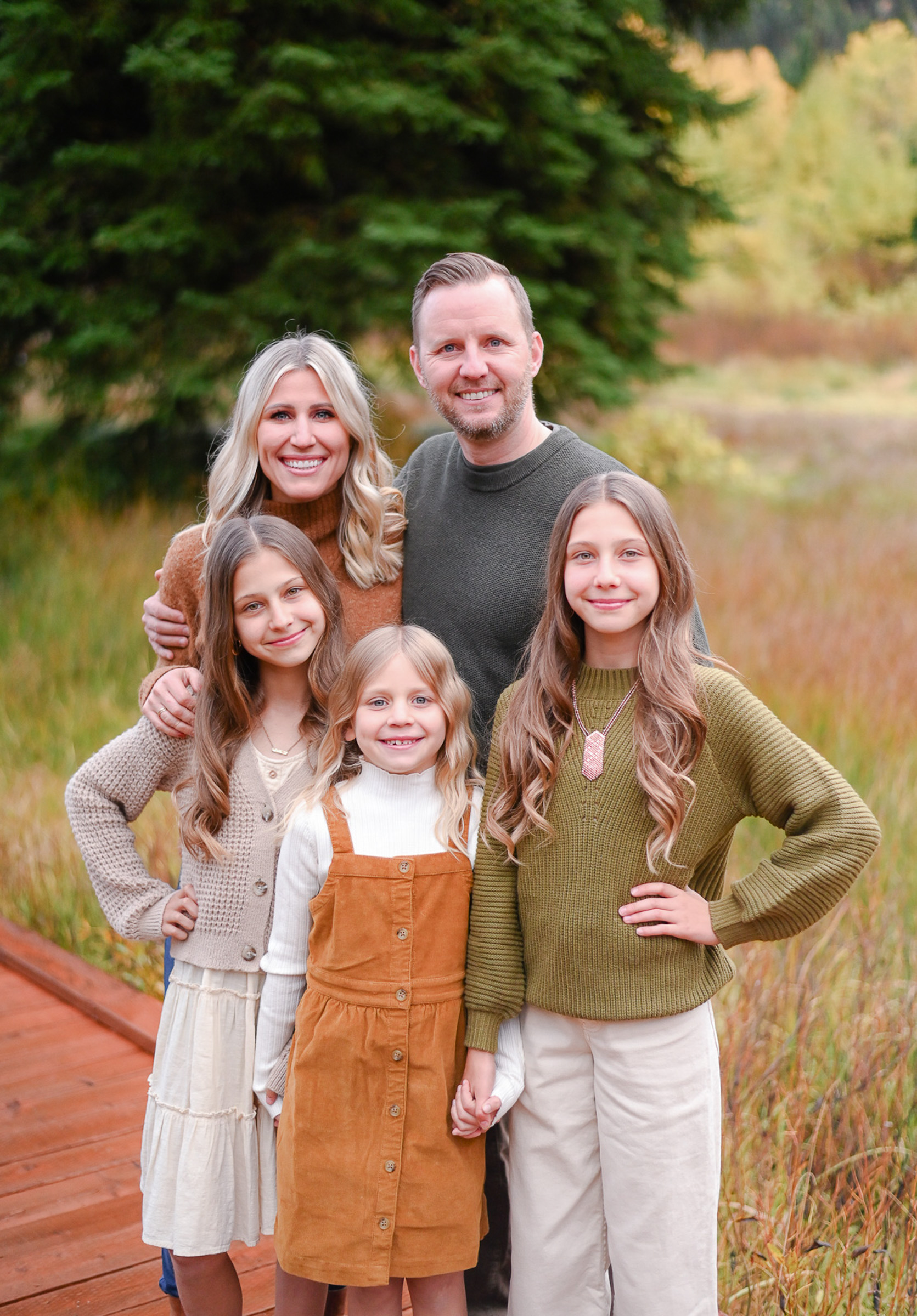 Family smiling and having fun in the crisp fall evening in Cottonwood Canyon, Utah. Fall family photos in Cottonwood Canyon