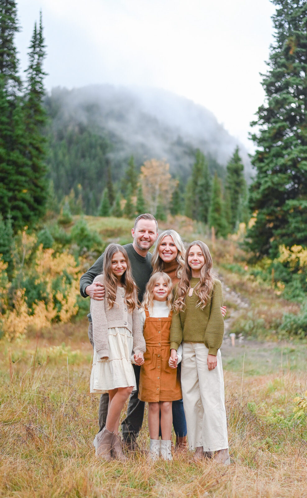 Family smiling in the crisp fall evening in Cottonwood Canyon, Utah. Fall family photos in Cottonwood Canyon