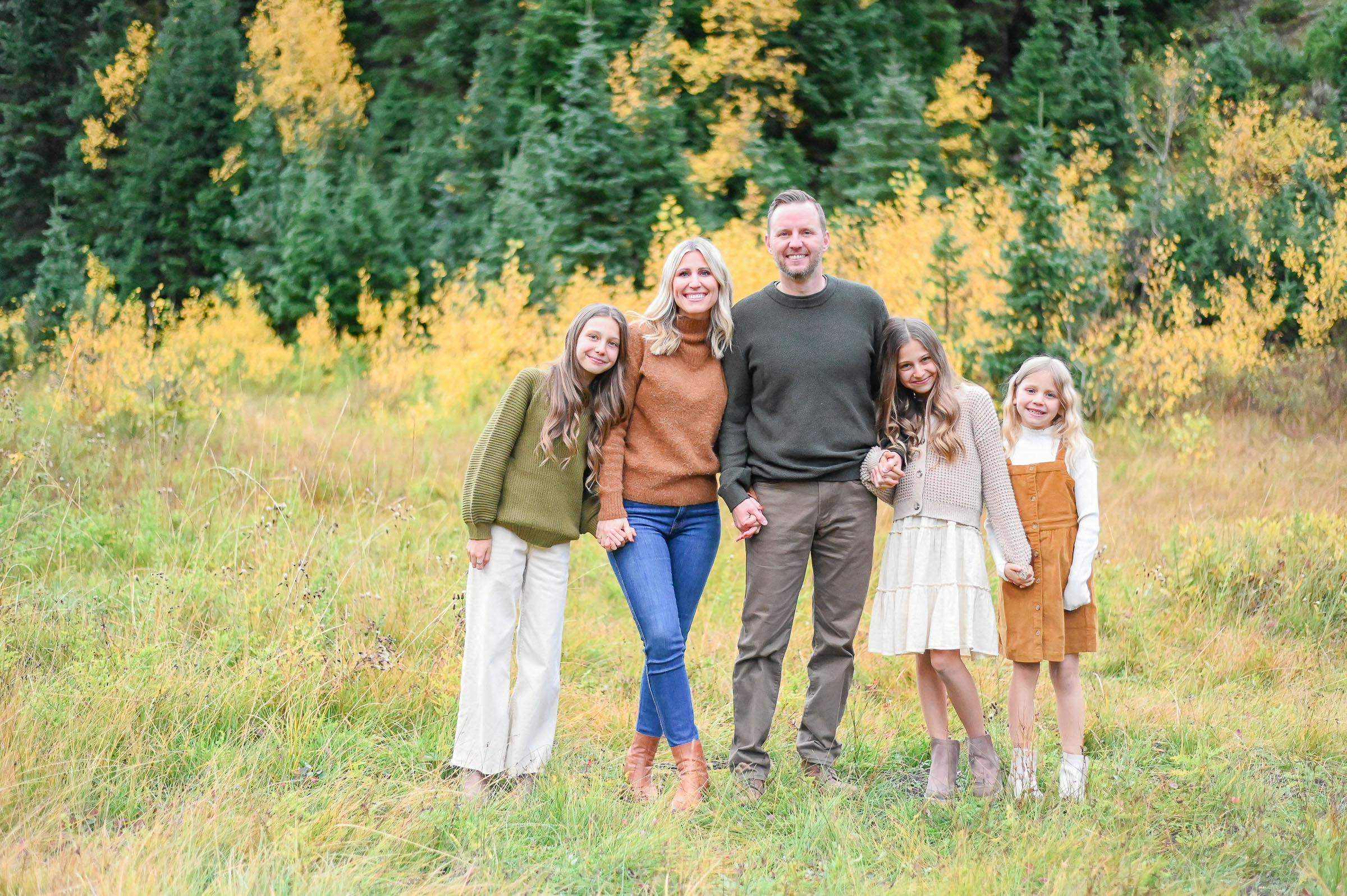 Family walking and laughing in the crisp fall evening in Cottonwood Canyon, Utah. Fall family photos in Cottonwood Canyon. Fall family photos in Cottonwood Canyon