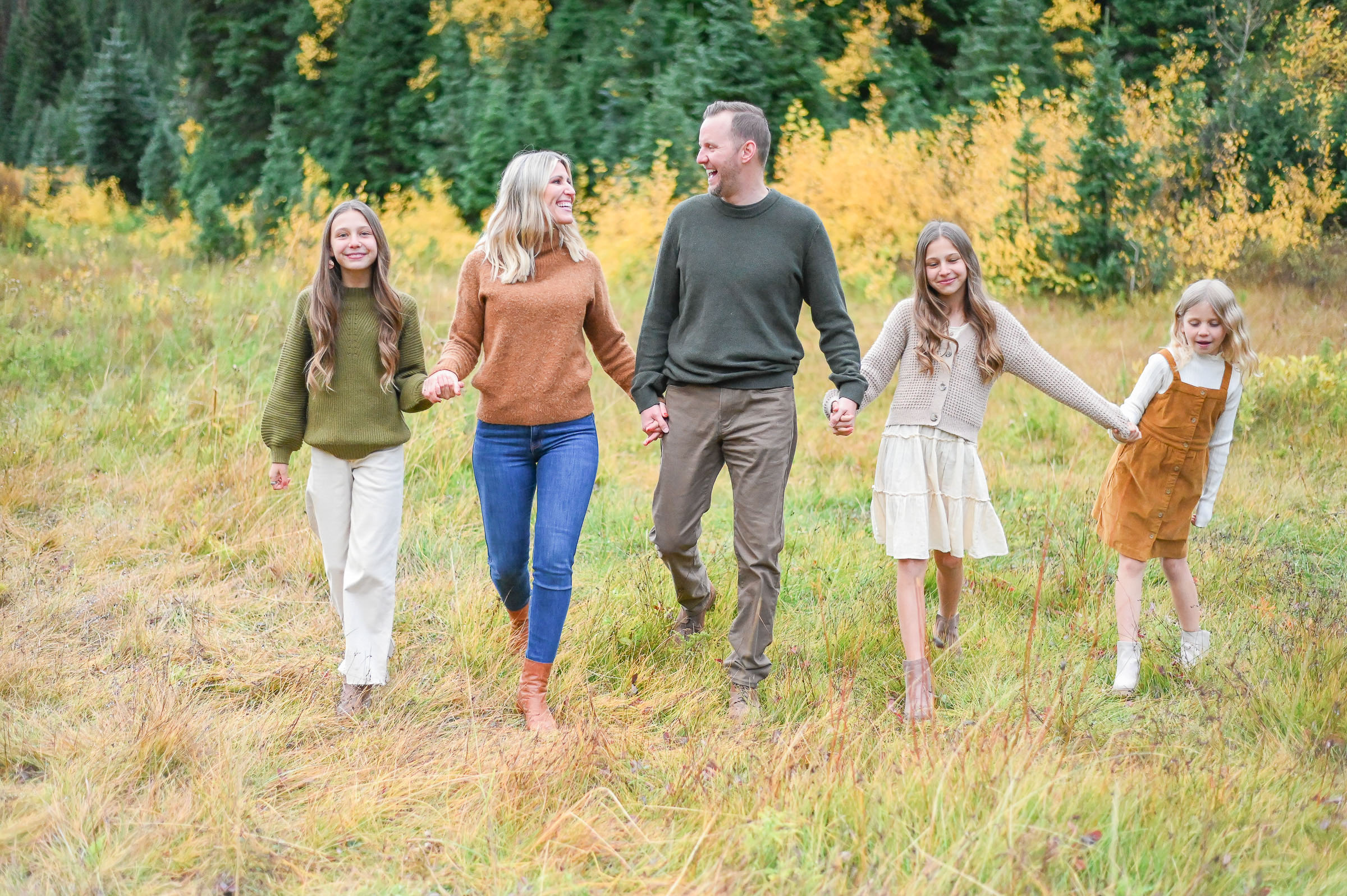 Family walking and laughing in the crisp fall evening in Cottonwood Canyon, Utah. Fall family photos in Cottonwood Canyon