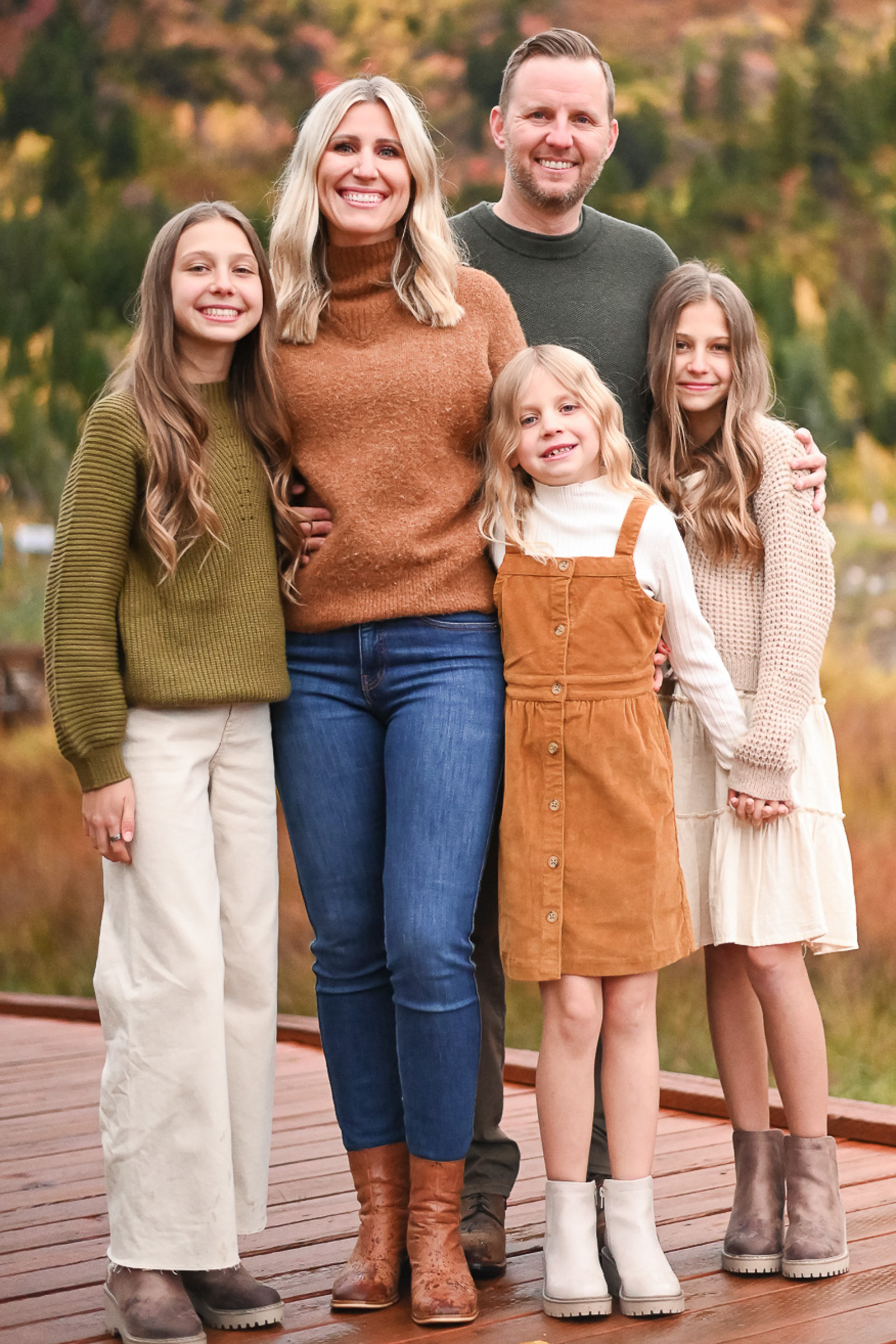 Family smiling and having fun in the crisp fall evening in Cottonwood Canyon, Utah. Fall family photos in Cottonwood Canyon