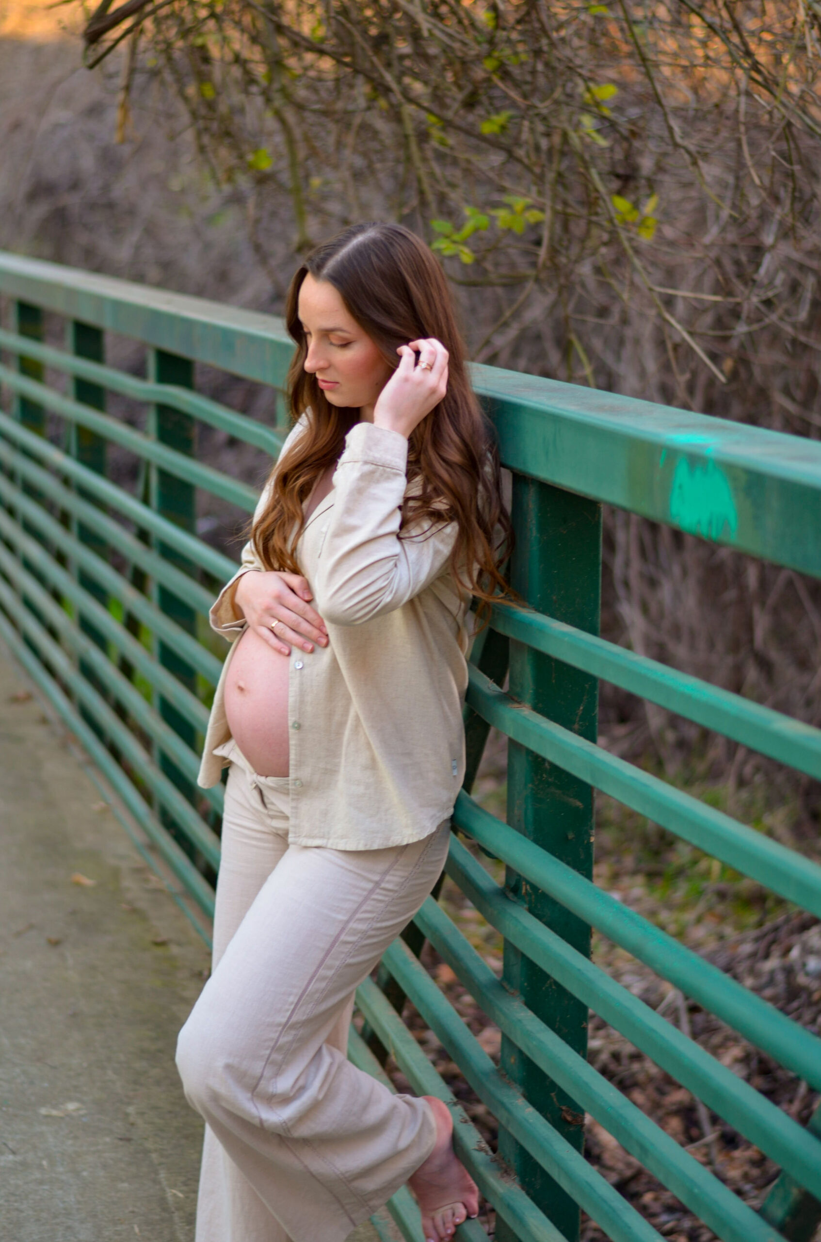 Mother to be on a bridge for her maternity shoot in Ripon, CA. Army Corps Park