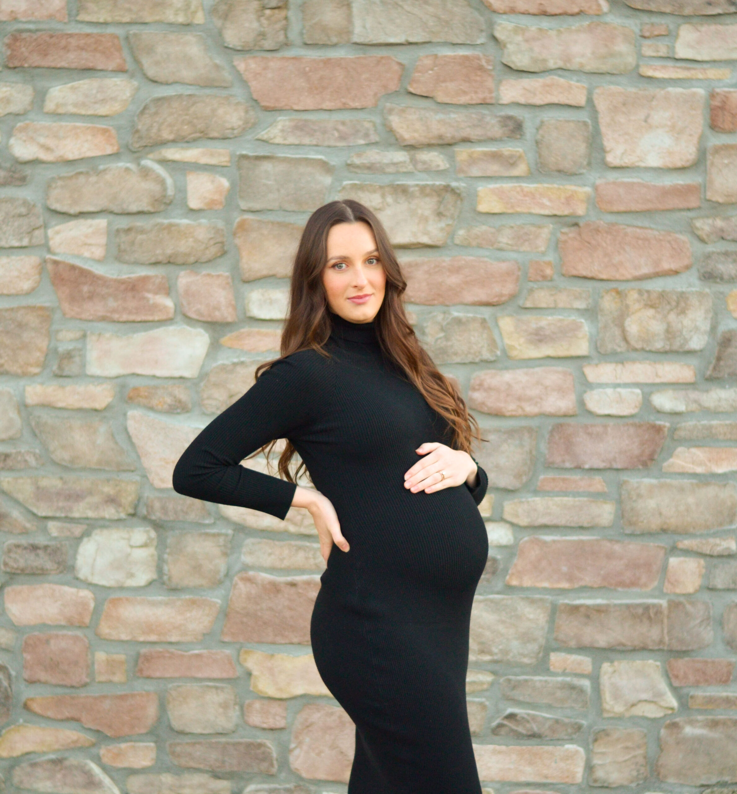 Mother to be against a brick wall during golden hour for her maternity shoot in Ripon, CA.