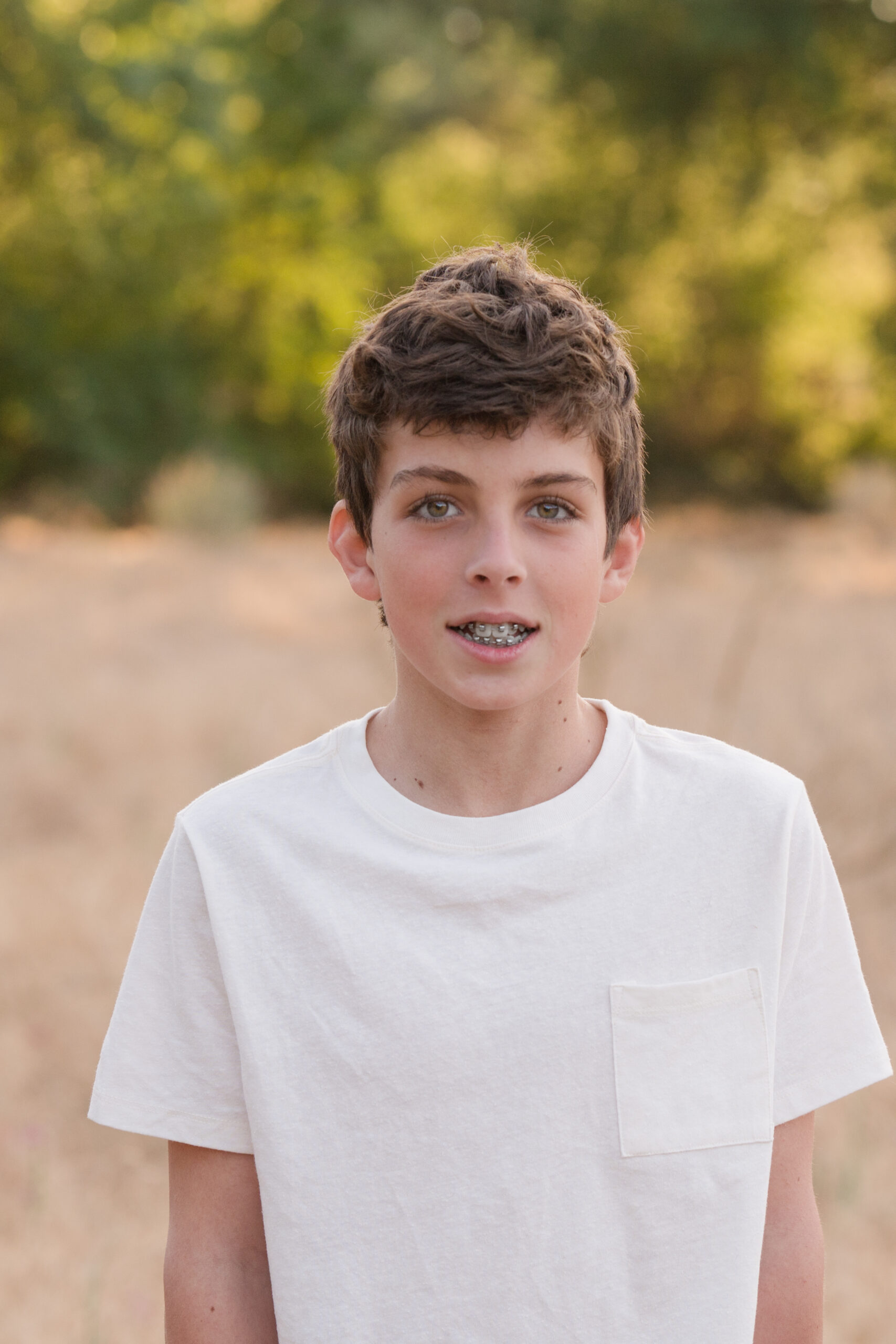 A boy looks at the camera as he puts on his best posture and pose for his shining moment at Oak Grove Park in Ripon California.