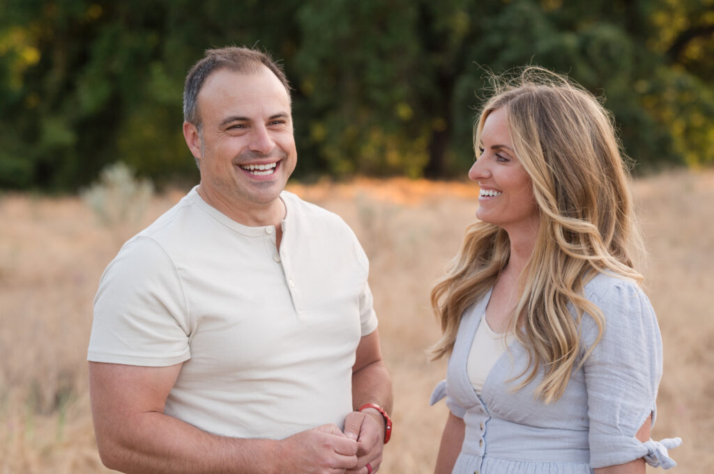 Husband and wife caught in laughter in a candid moment in Oak Grove Park, Ripon, California.