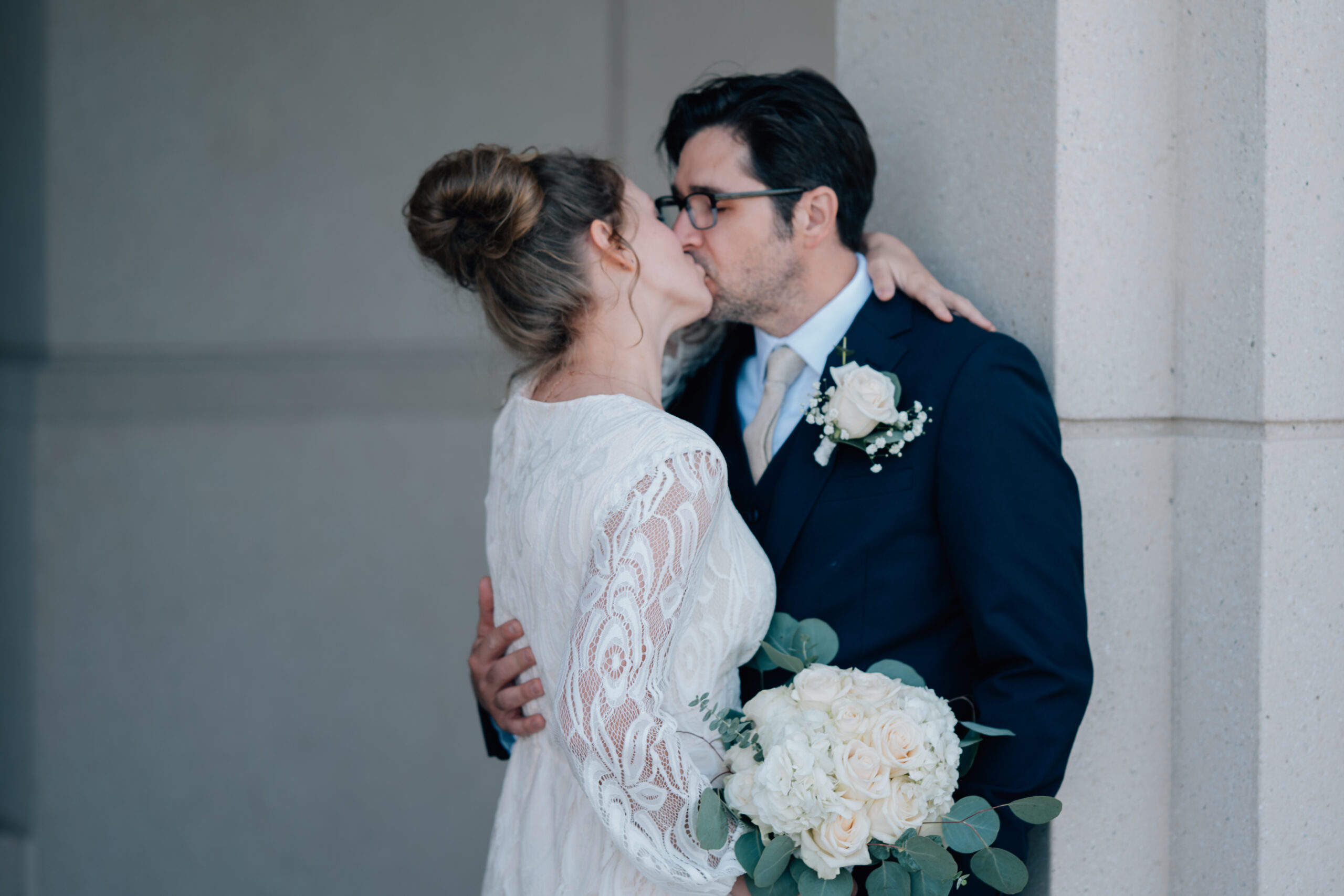 This cute bride and groom steal a kiss in a framed doorway. Saratoga Springs, UT