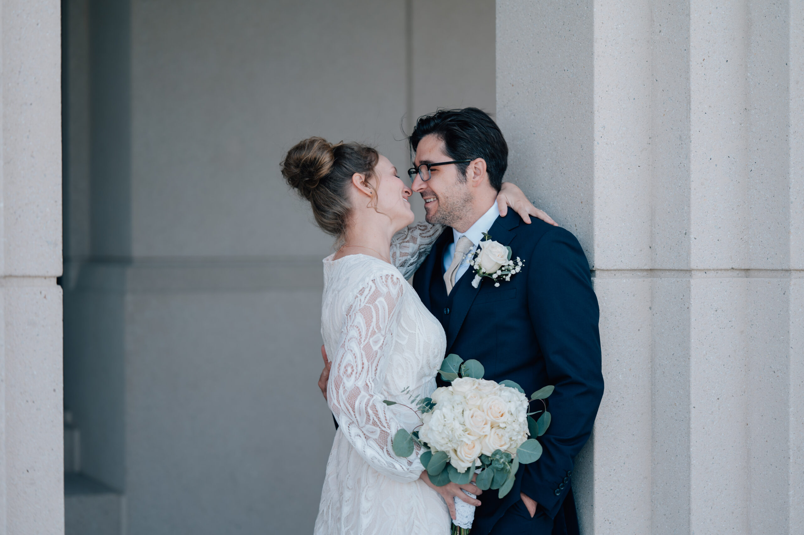 Bride looks at her groom bringing both to smile effortlessly at one another.