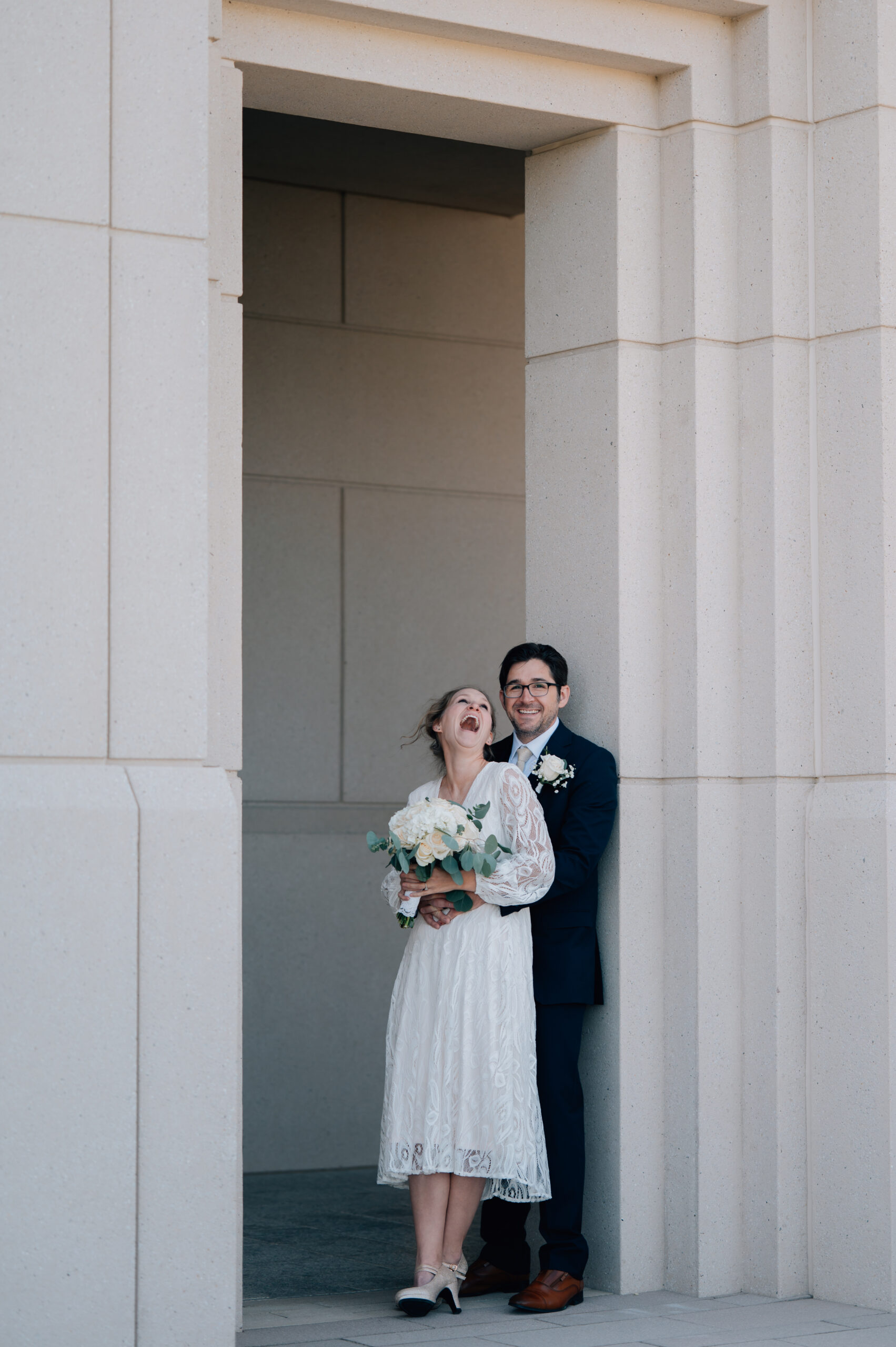Bride laughs at her cute hubby. Groom smiles on.