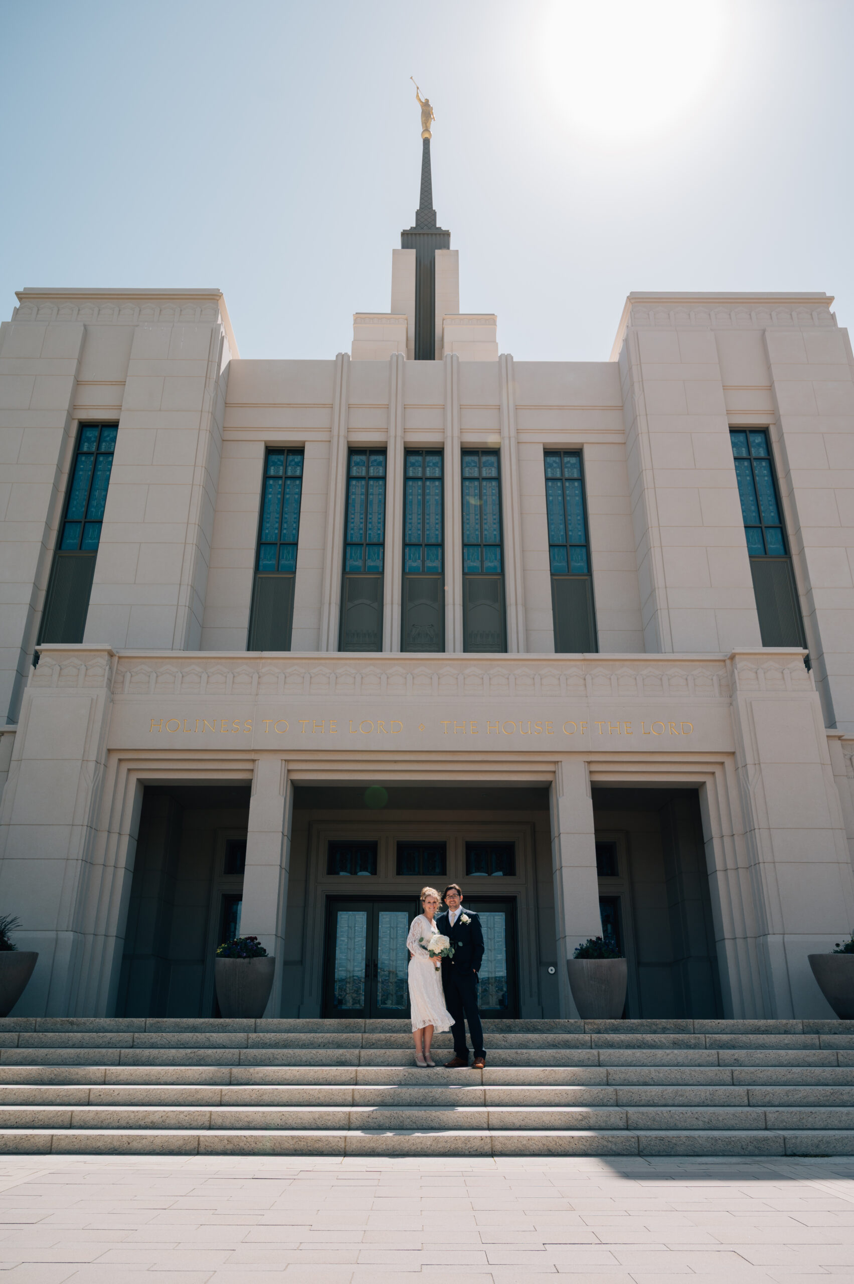 Bride and Groom pose on the steps of the LDS temple in Saratoga Springs UT.