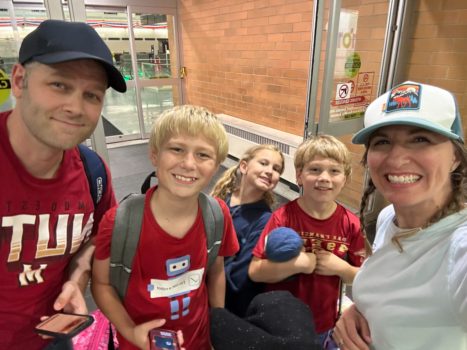 Family of five outside of the Midway airport waiting for the shuttle.