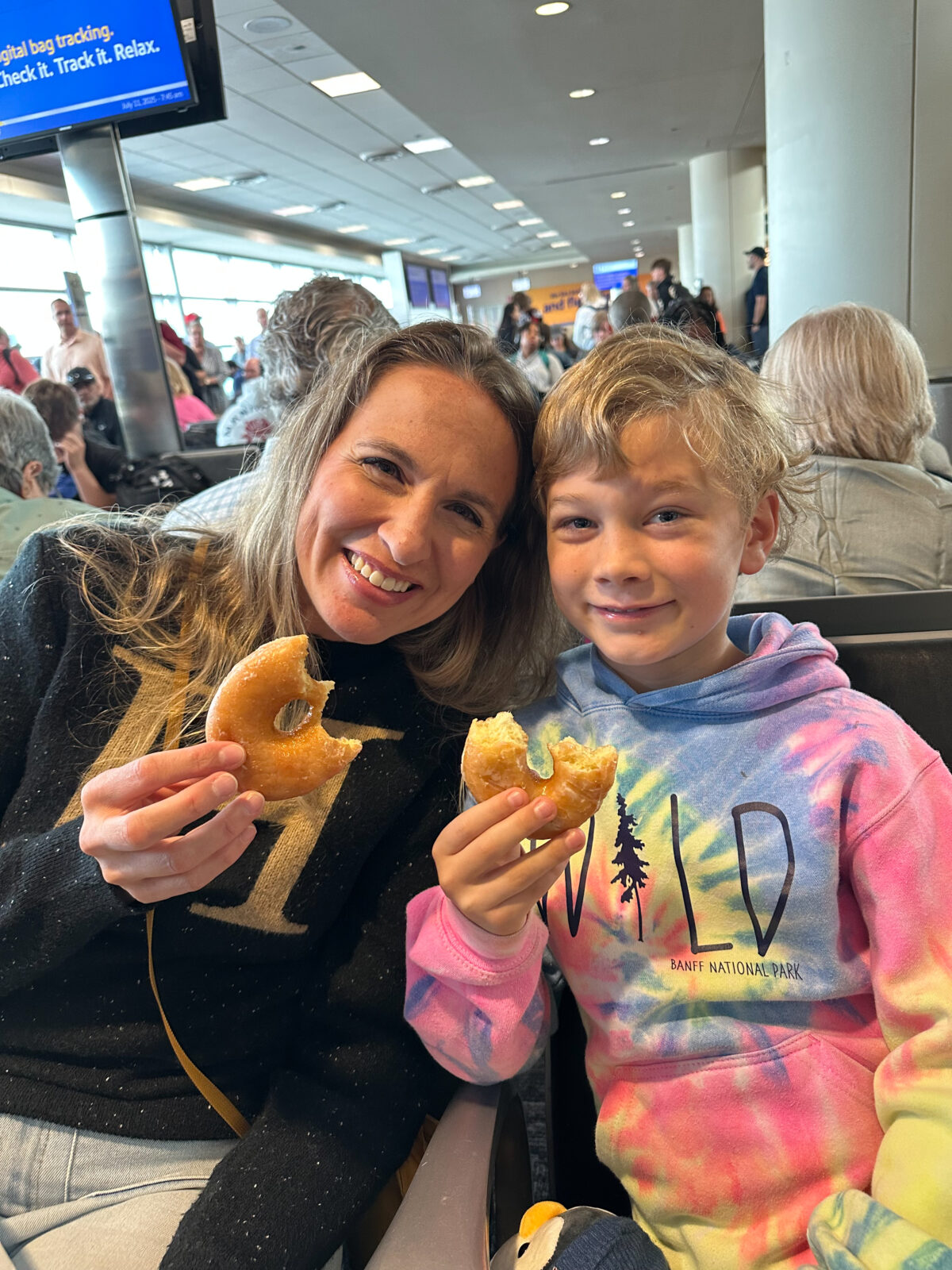 Mom and son showing off their Dunkin Donuts in the Midway airport.