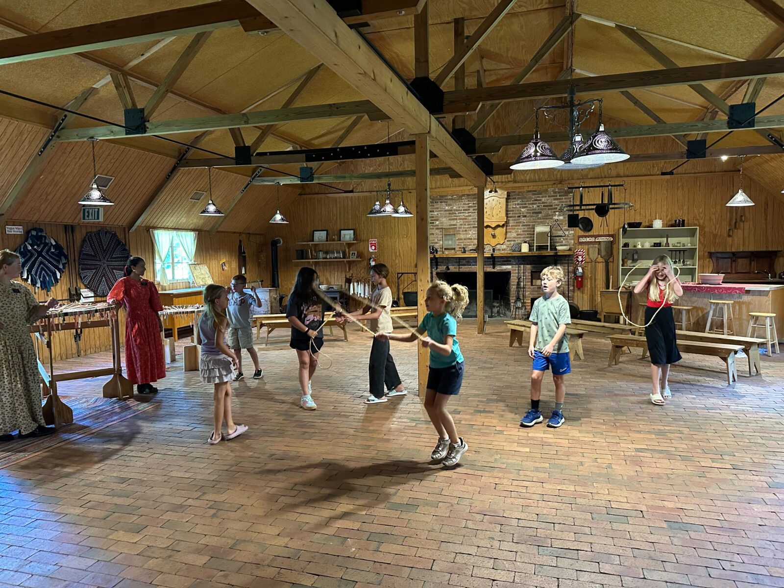 A bunch of kids jumping rope in an activity center.