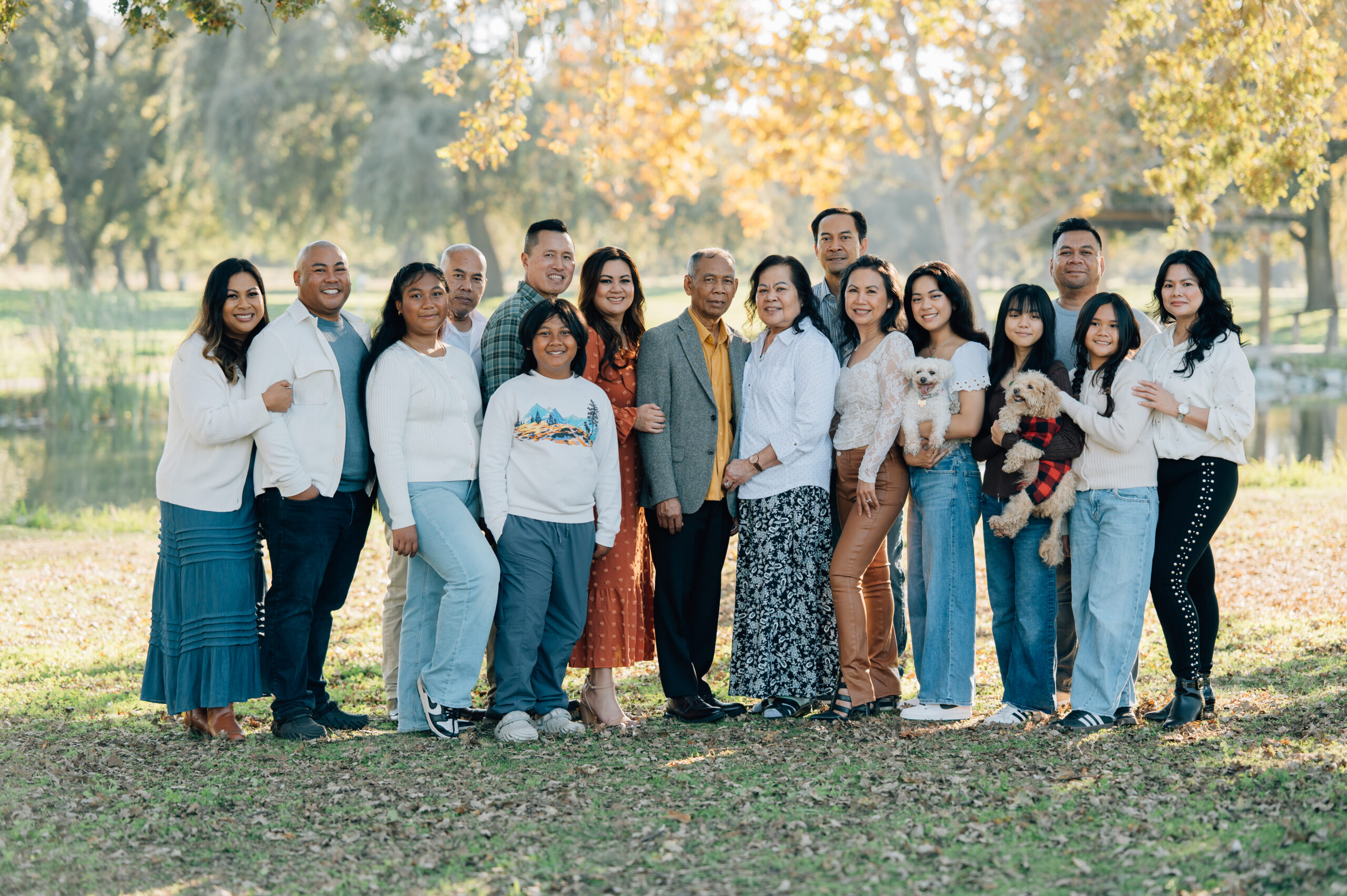 Extended family portrait at Oak Grove Park in North Stockton with multiple generations smiling together in fall light