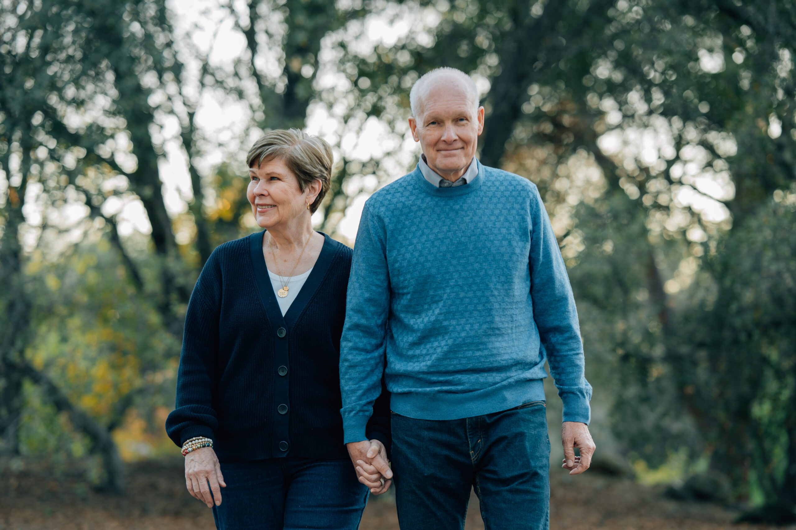 Grandparents standing together surrounded by nature during a legacy photography session