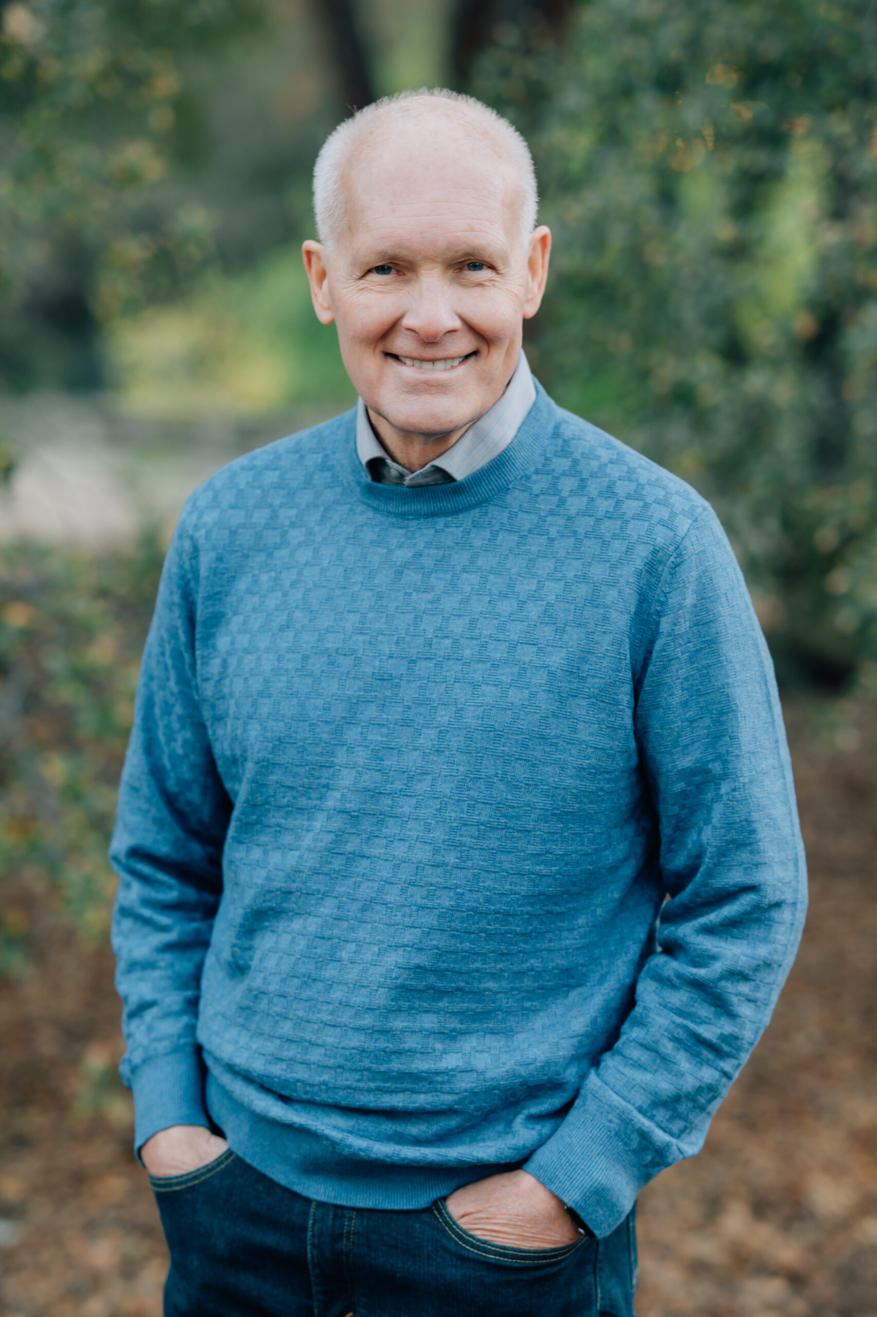 Grandparents standing together surrounded by nature during a legacy photography session