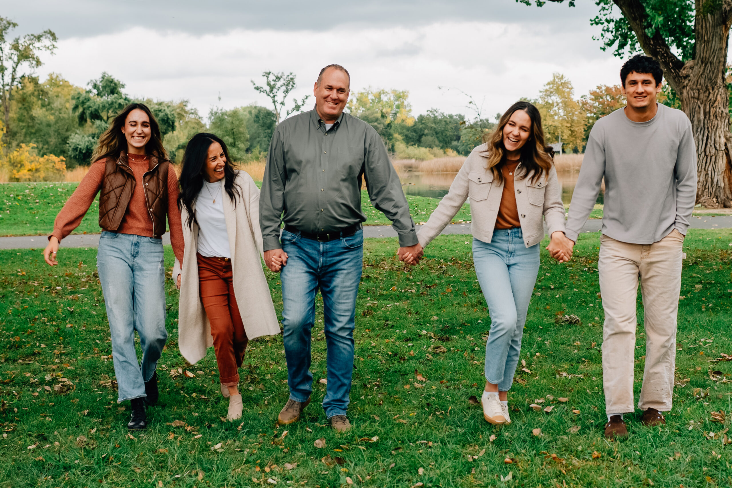Family of five laughing together at Lodi Lake during an autumn family photography session
