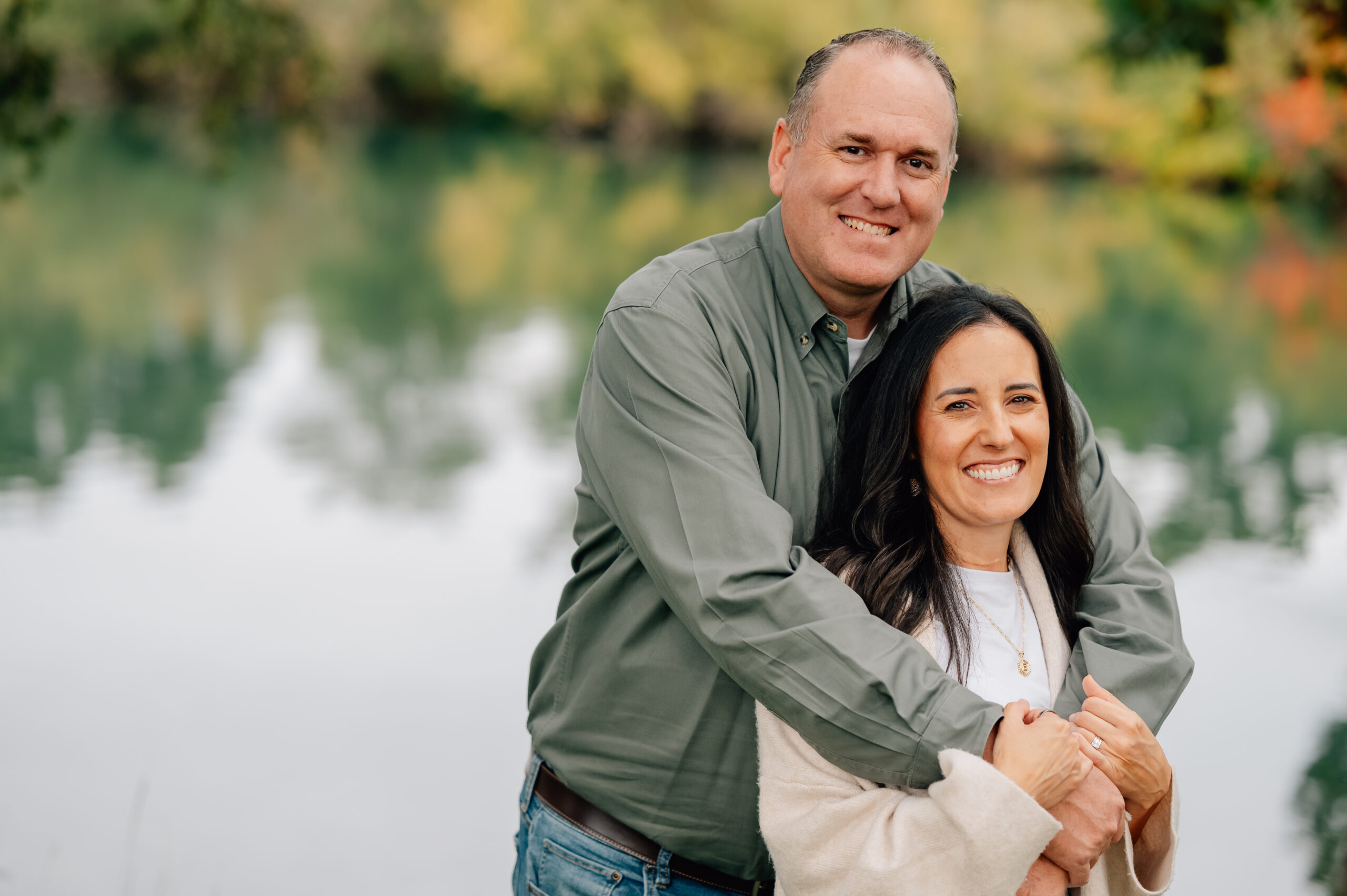 Close-up of parents smiling together during a golden fall family session at Lodi Lake