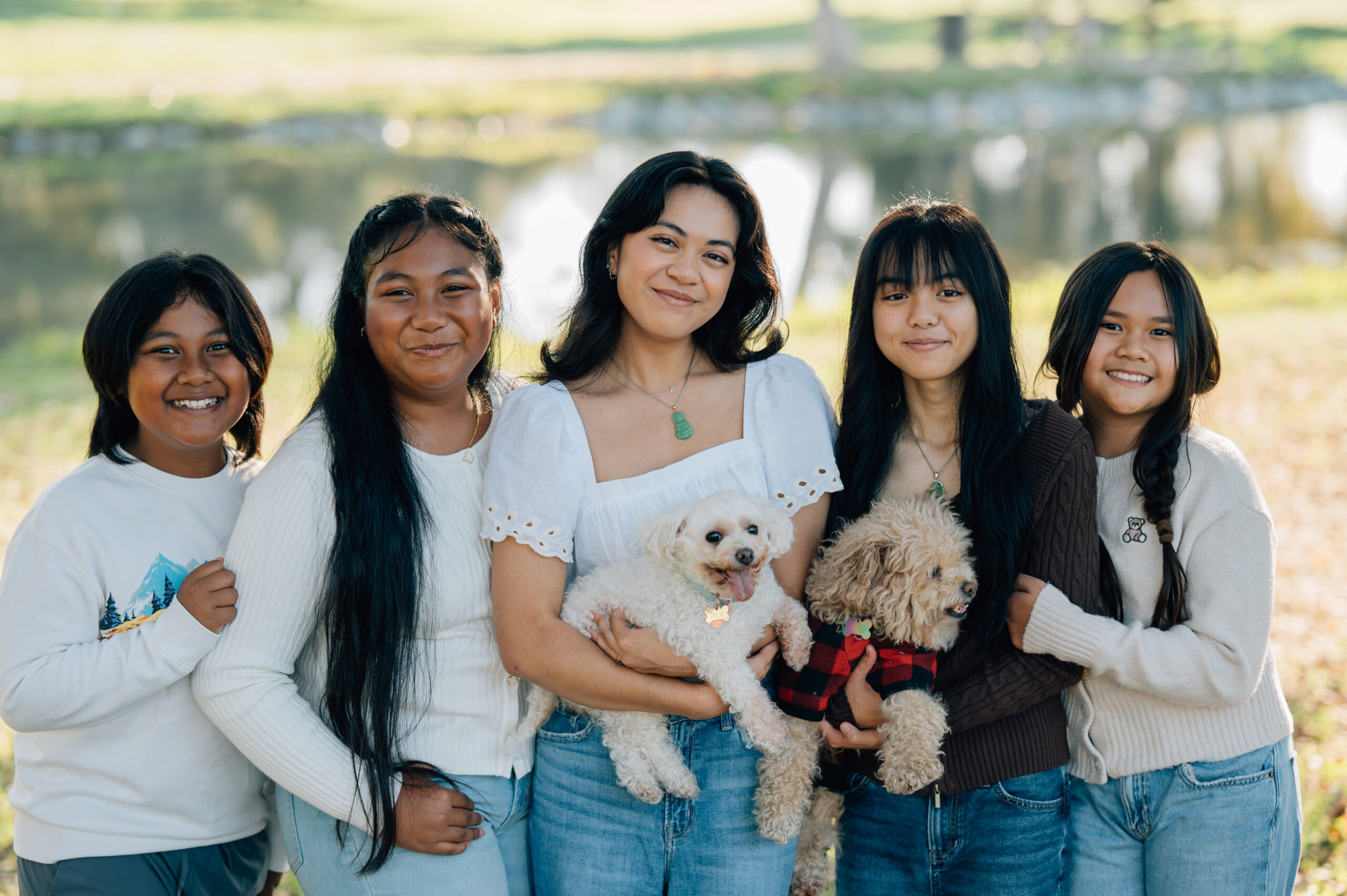 Cousins posing together under willow trees at Oak Grove Park during sunset