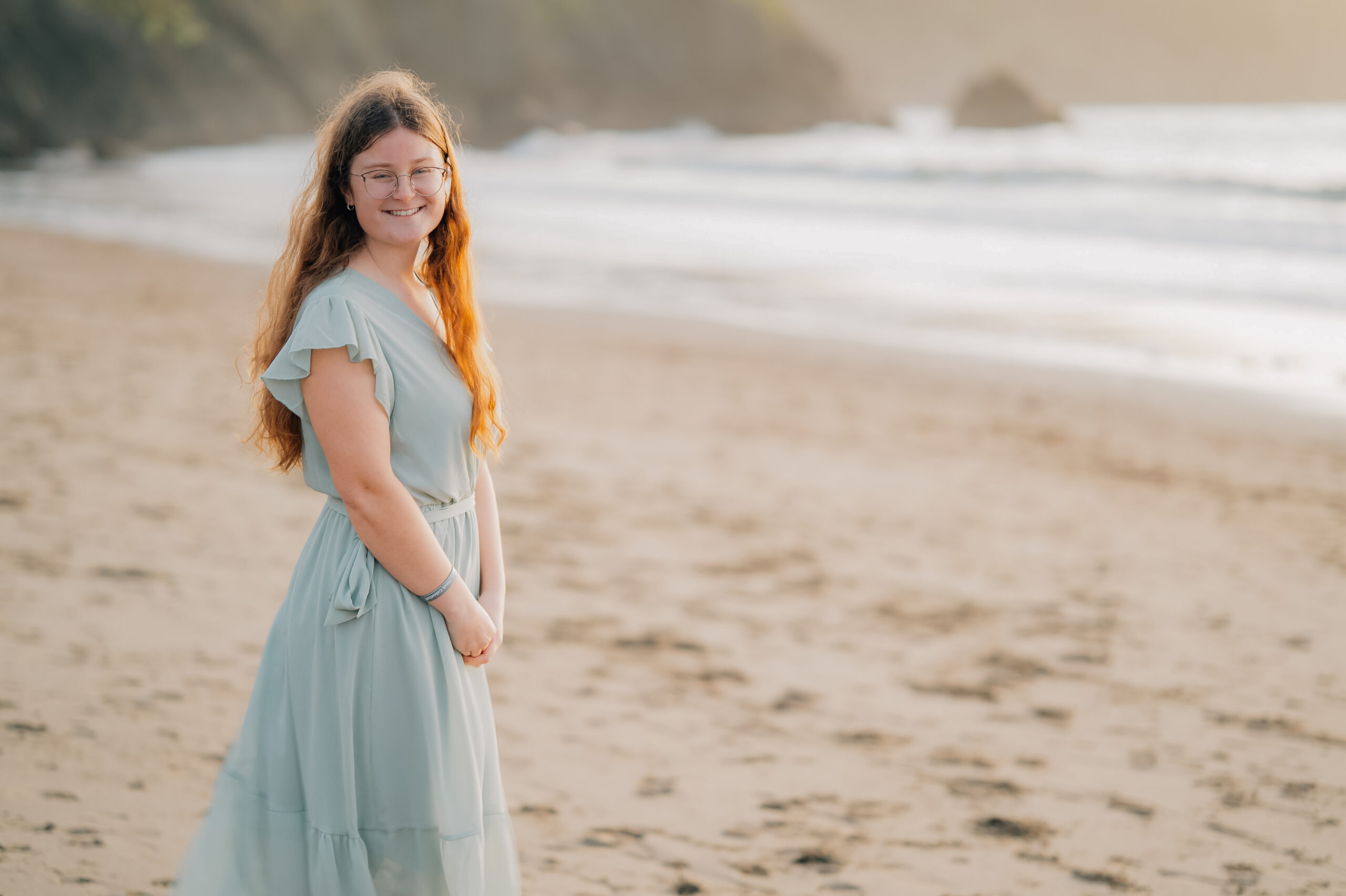 San Francisco senior session at Baker Beach with cliffs and golden sunset light.