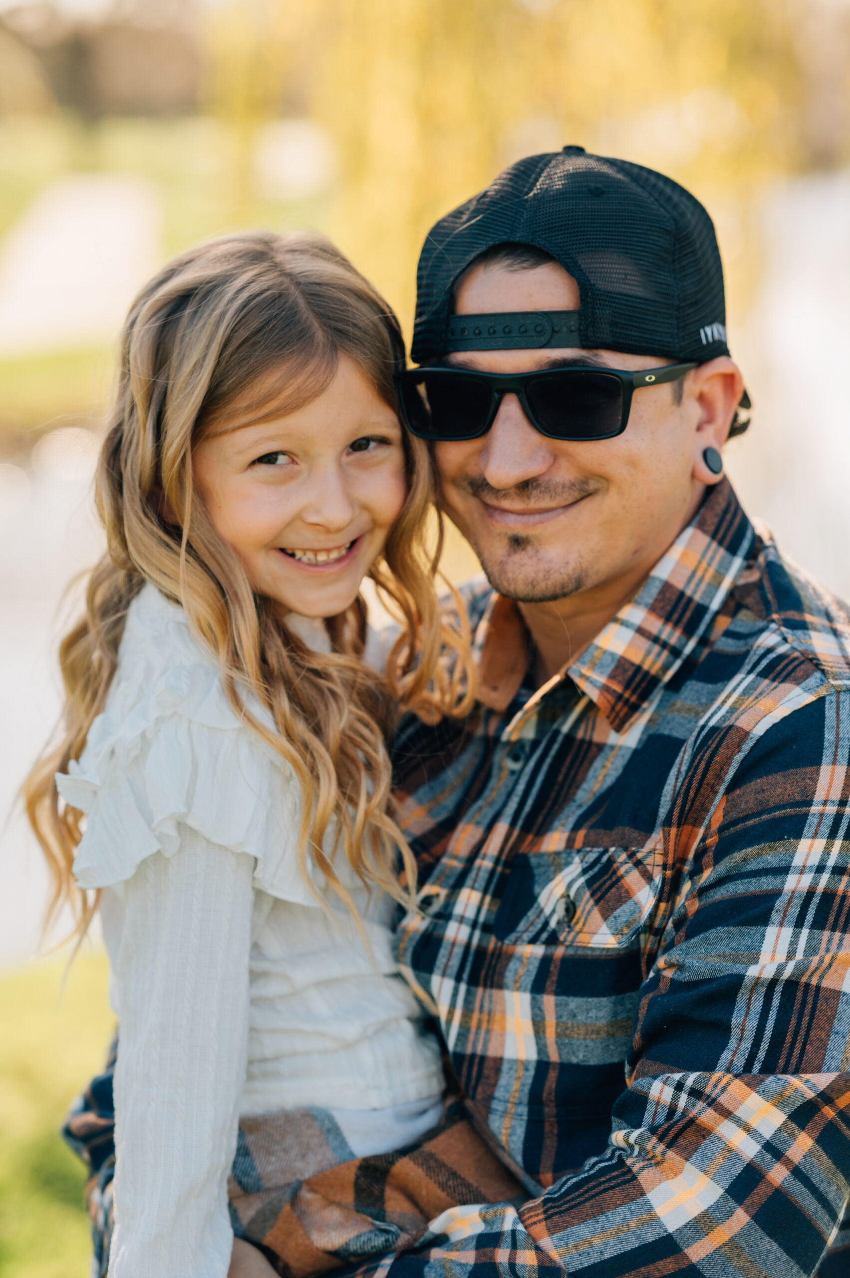 father and daughter smiling during outdoor family session