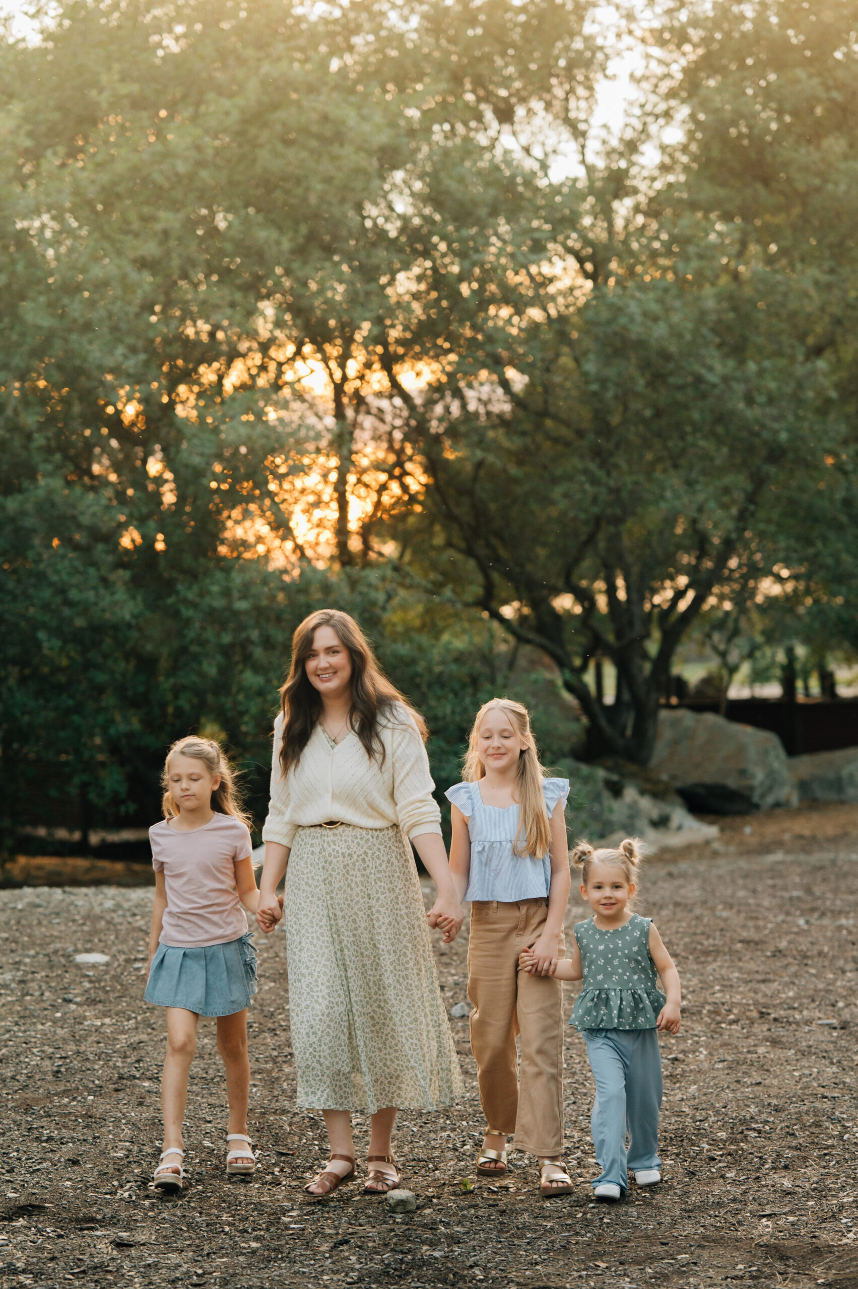 Mom and three daughters standing together during a natural outdoor family session in Rocklin CA
