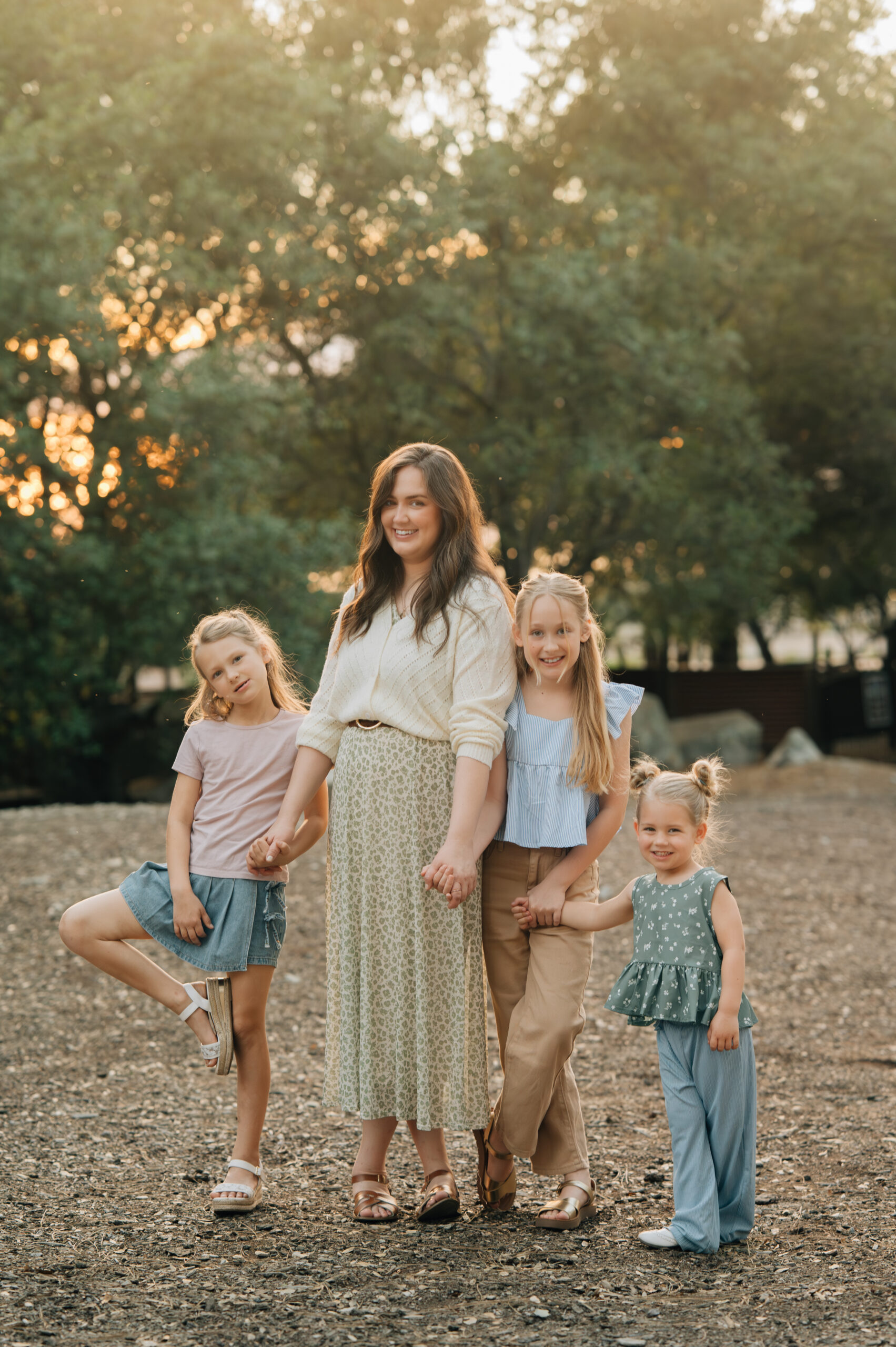Mom and three daughters standing together during a natural outdoor family session in Rocklin CA