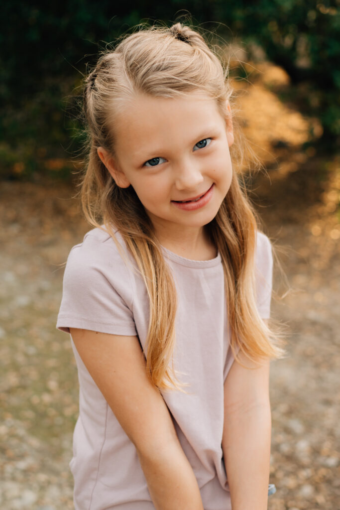 Close-up portrait of a young girl  during a playful outdoor family session
