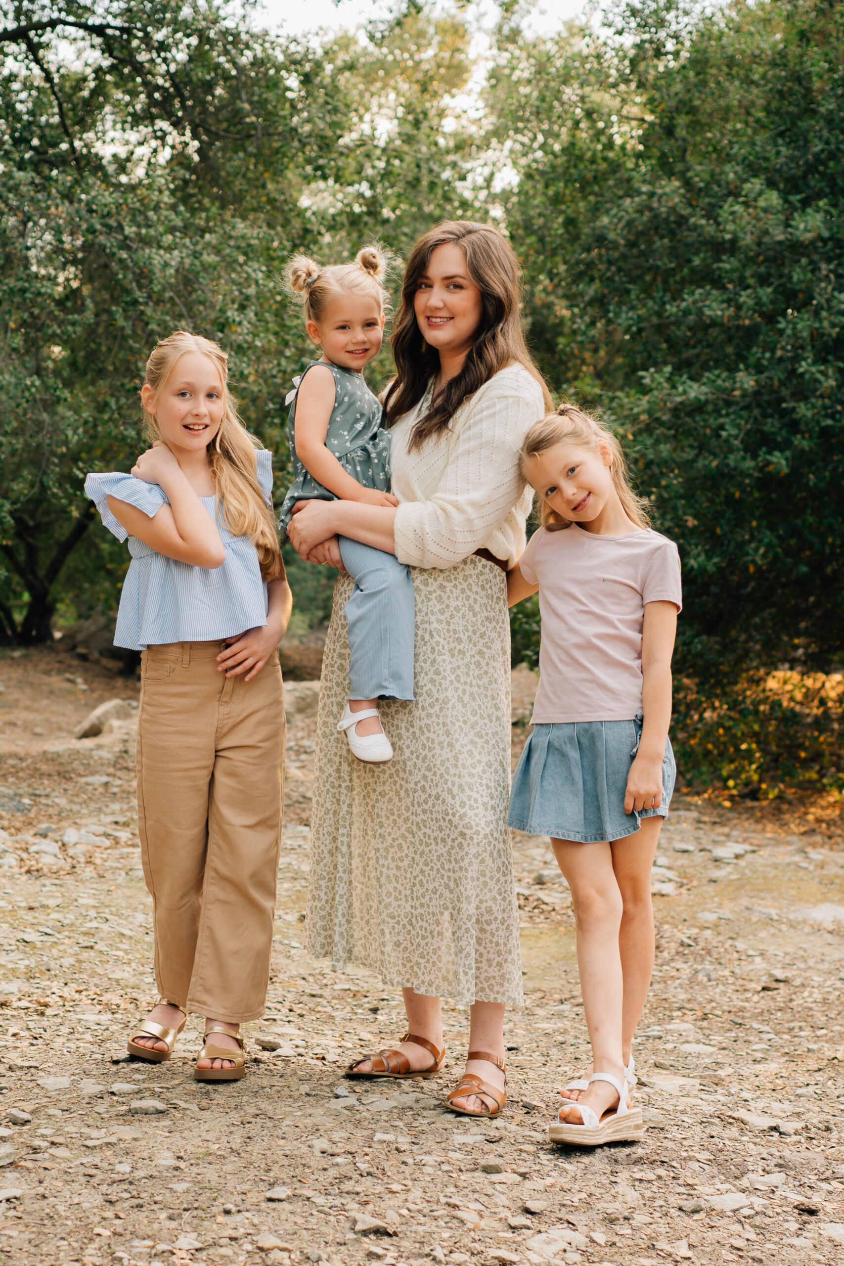Mom and three daughters standing together during a natural outdoor family session in Rocklin CA