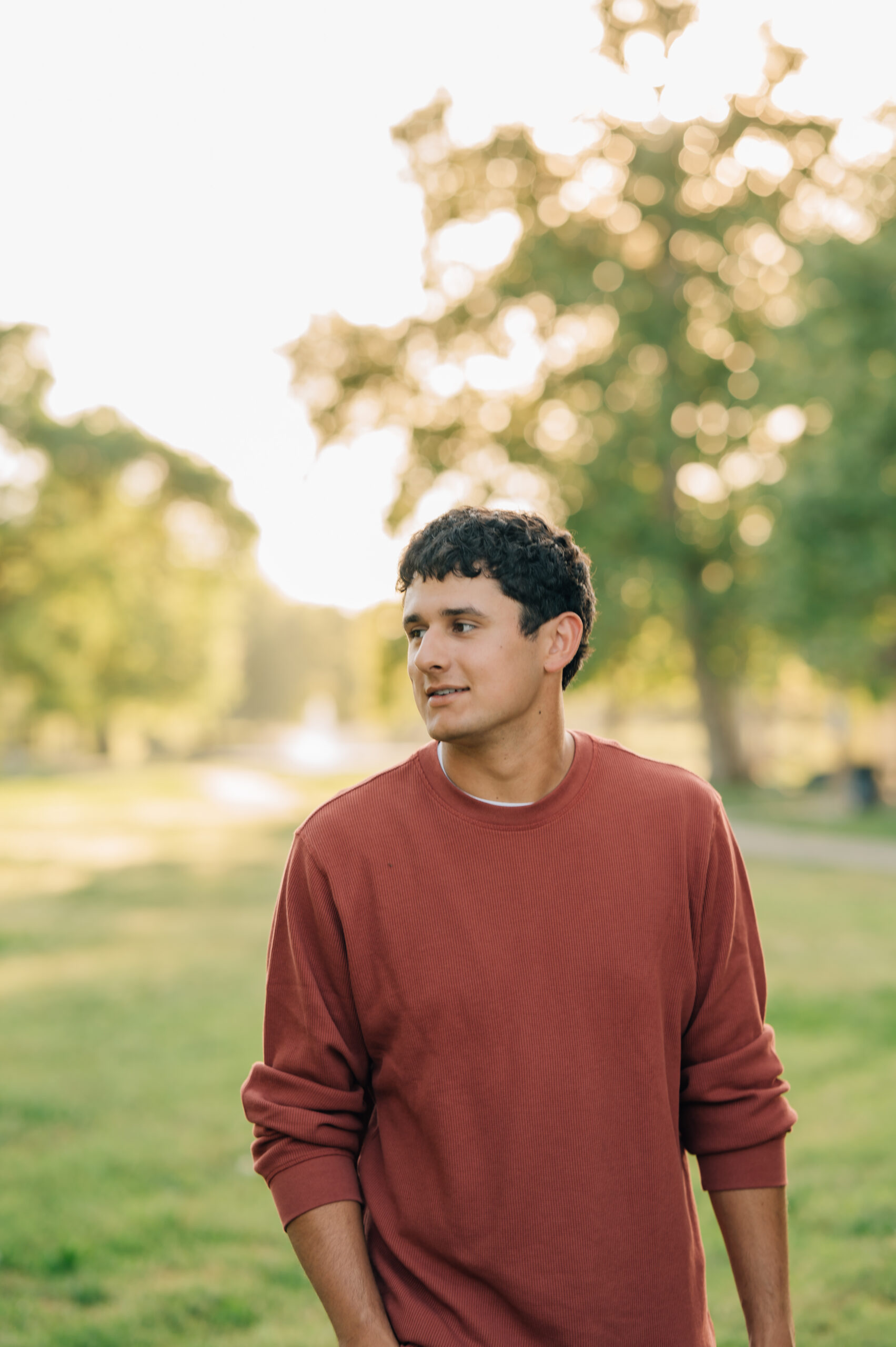Senior boy walking at Shumway Oak Grove Park in Stockton 