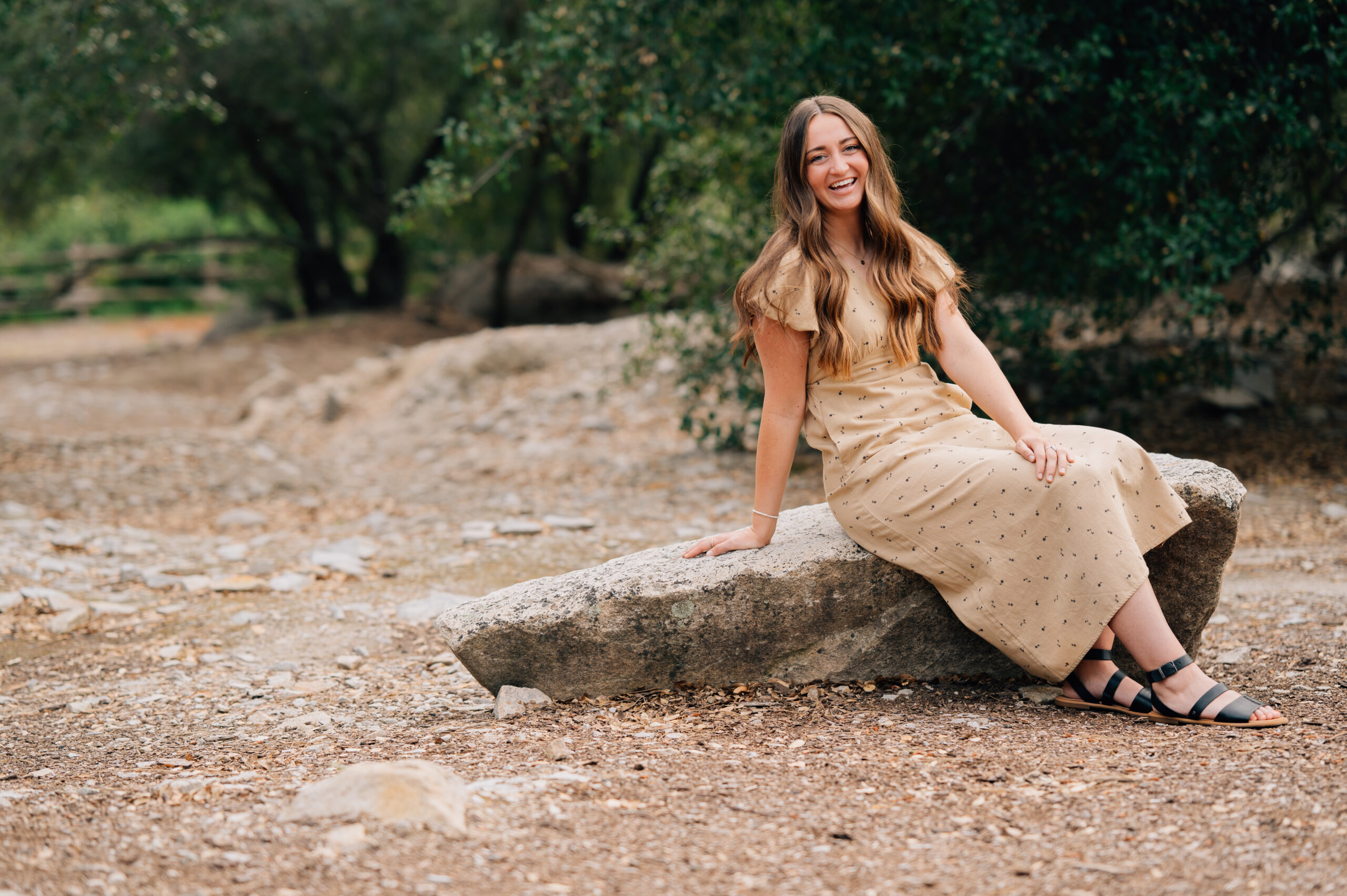 Young woman laughing during outdoor senior portrait session at Rocklin Quarry Park in California