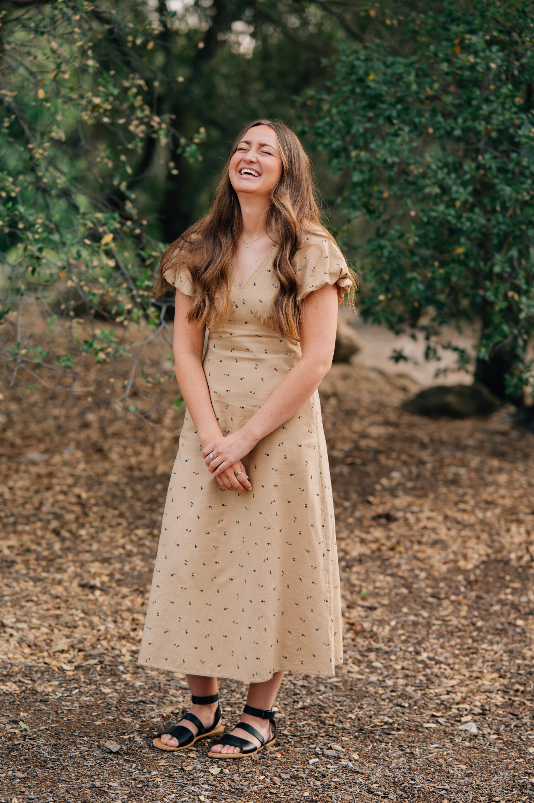 Young woman laughing during outdoor senior portrait session at Rocklin Quarry Park in California