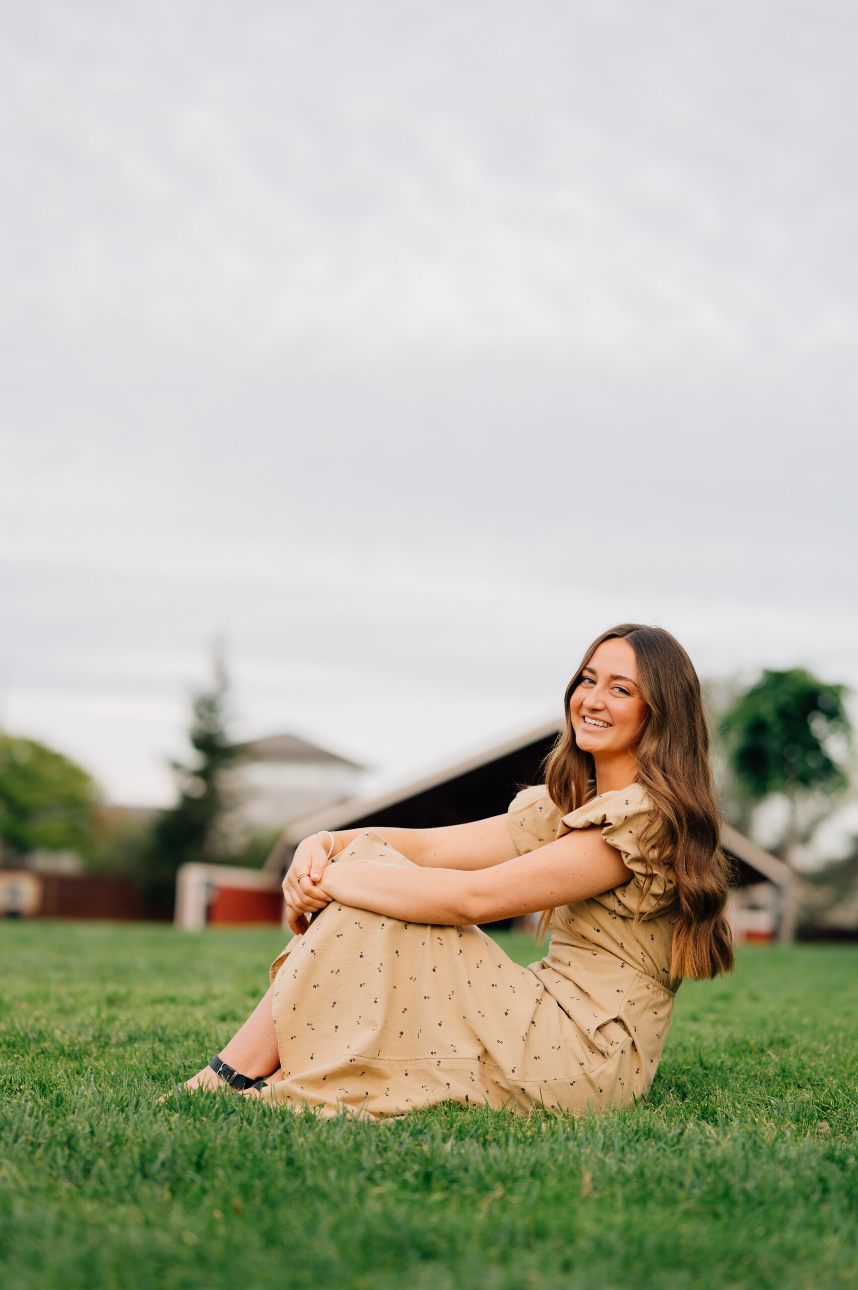 Senior portrait in grassy amphitheater area at Rocklin Quarry Park
