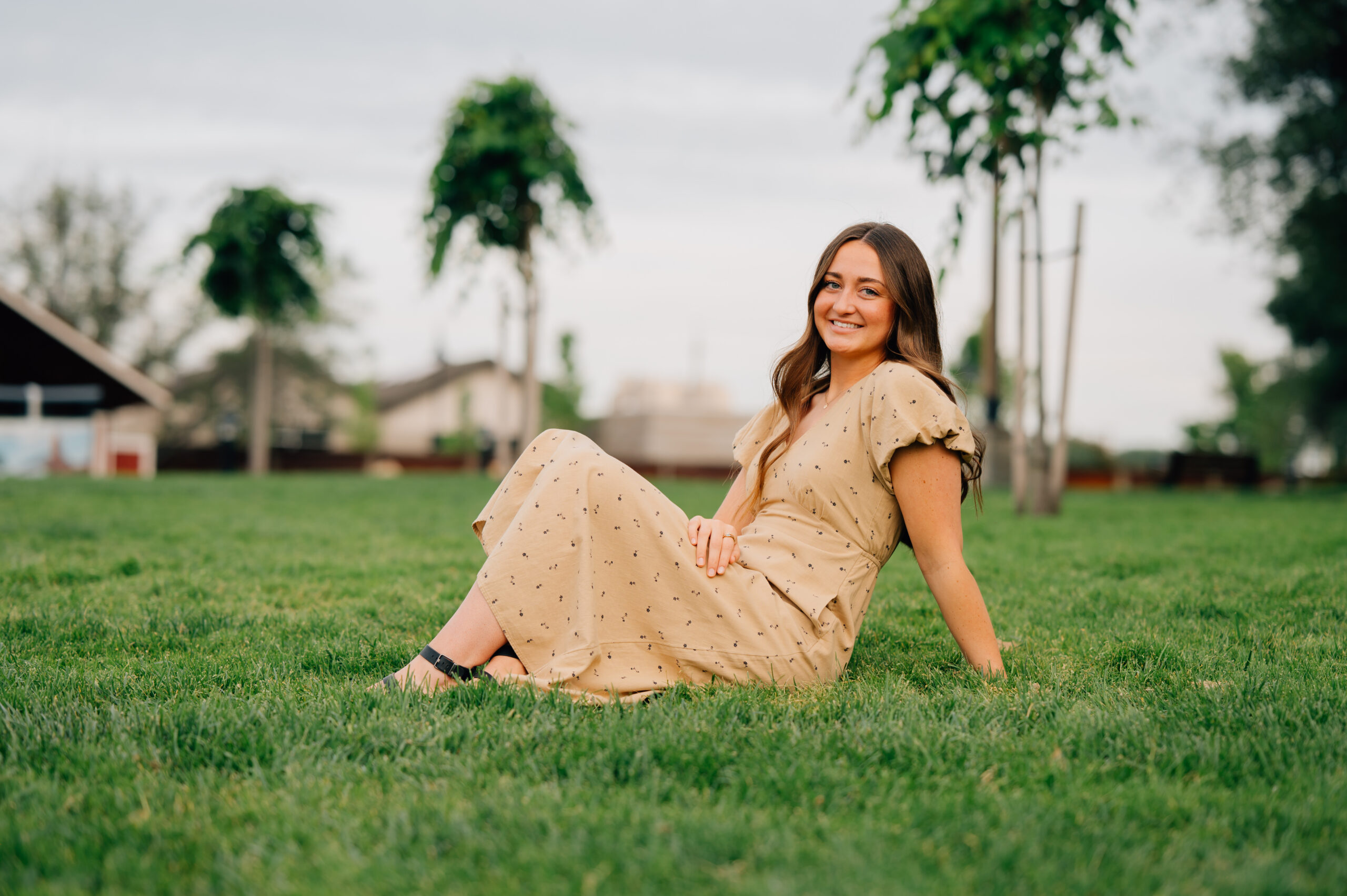 Senior portrait in grassy amphitheater area at Rocklin Quarry Park