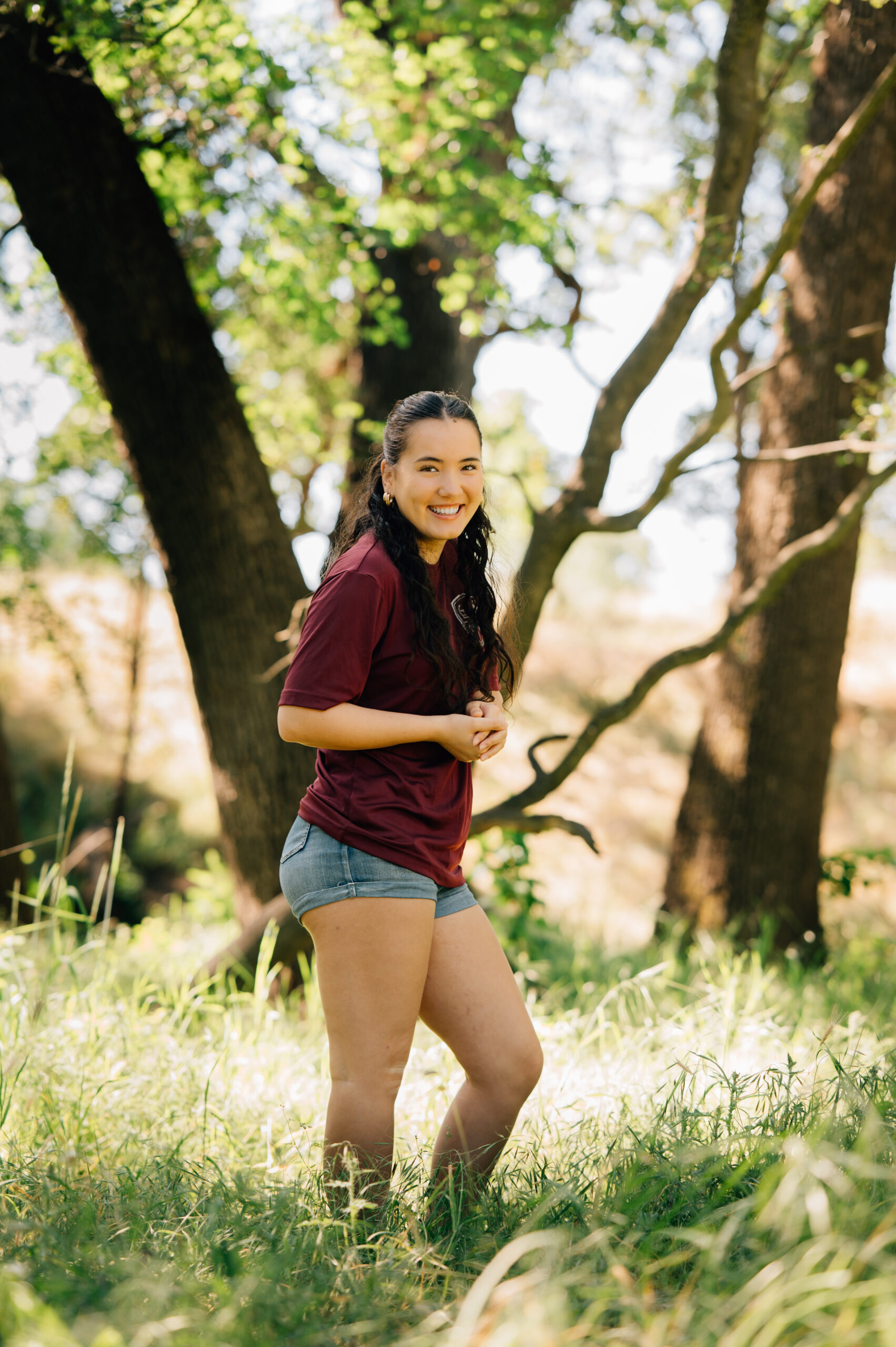Senior portraits in wooded field at Johnson Springview Park