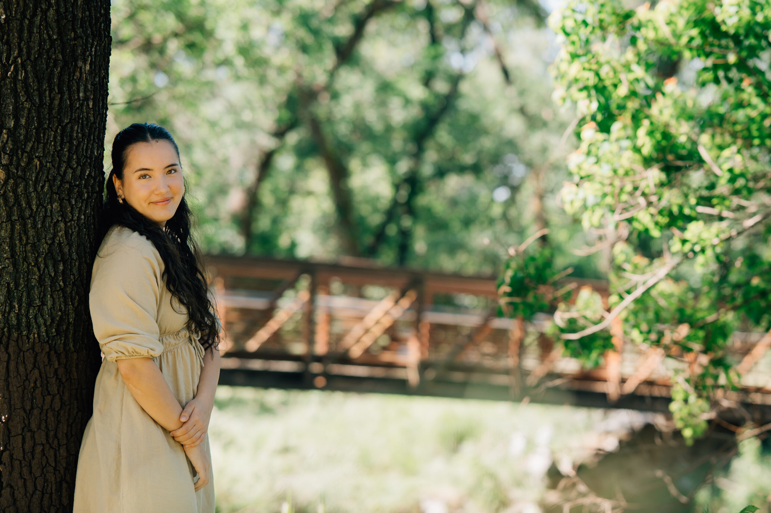 Senior girl standing among oak trees during Northern California senior session