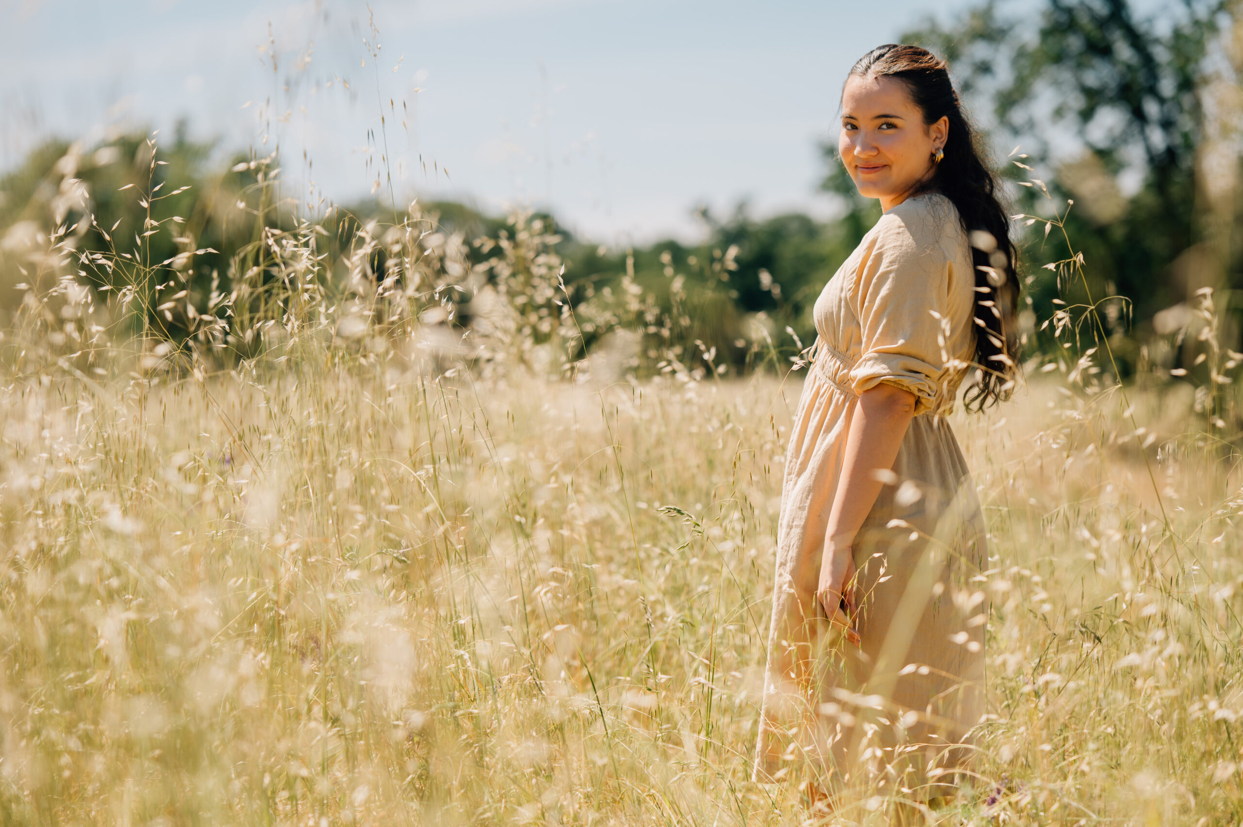 Outdoor senior session in golden grass field with oak trees in Northern California