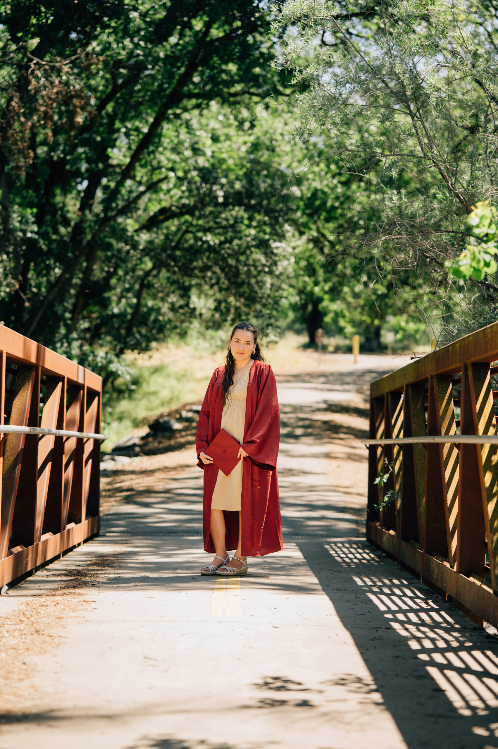 High school senior posing on bridge at Johnson Springview Park in Rocklin