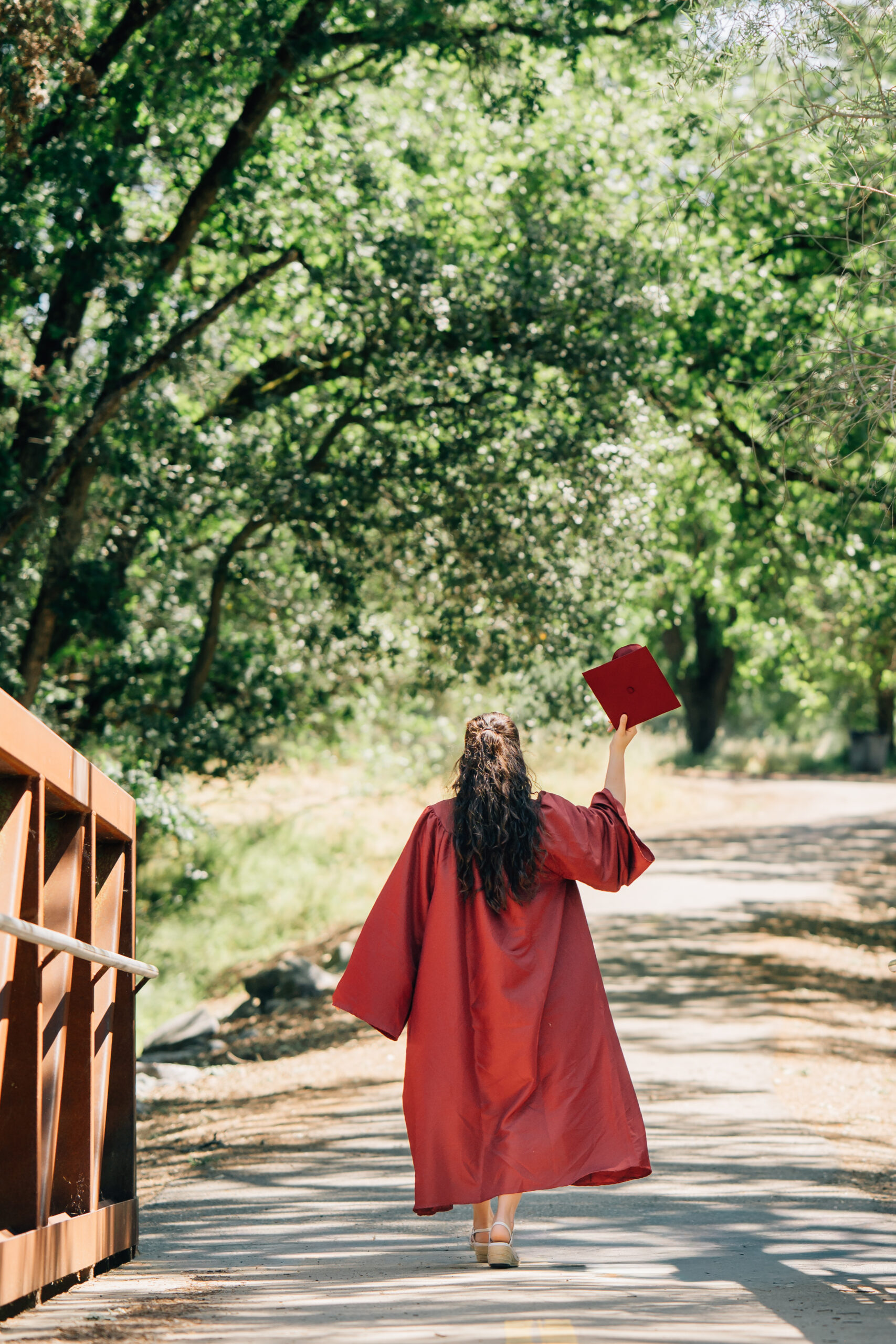 High school senior posing on bridge at Johnson Springview Park in Rocklin