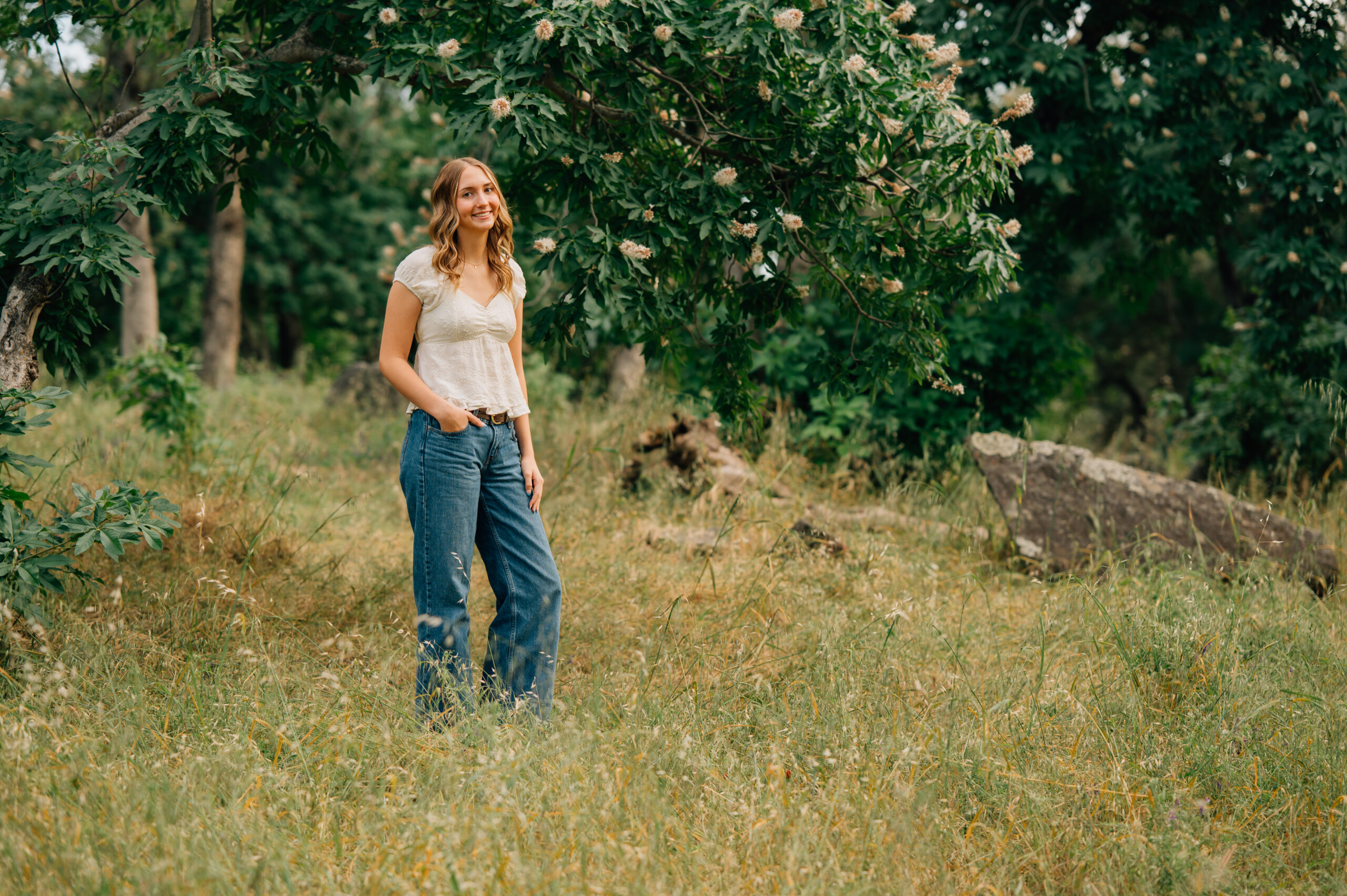 Senior girl standing in tall golden grass at Griffith Quarry Park in Penryn during a Northern California senior session.
