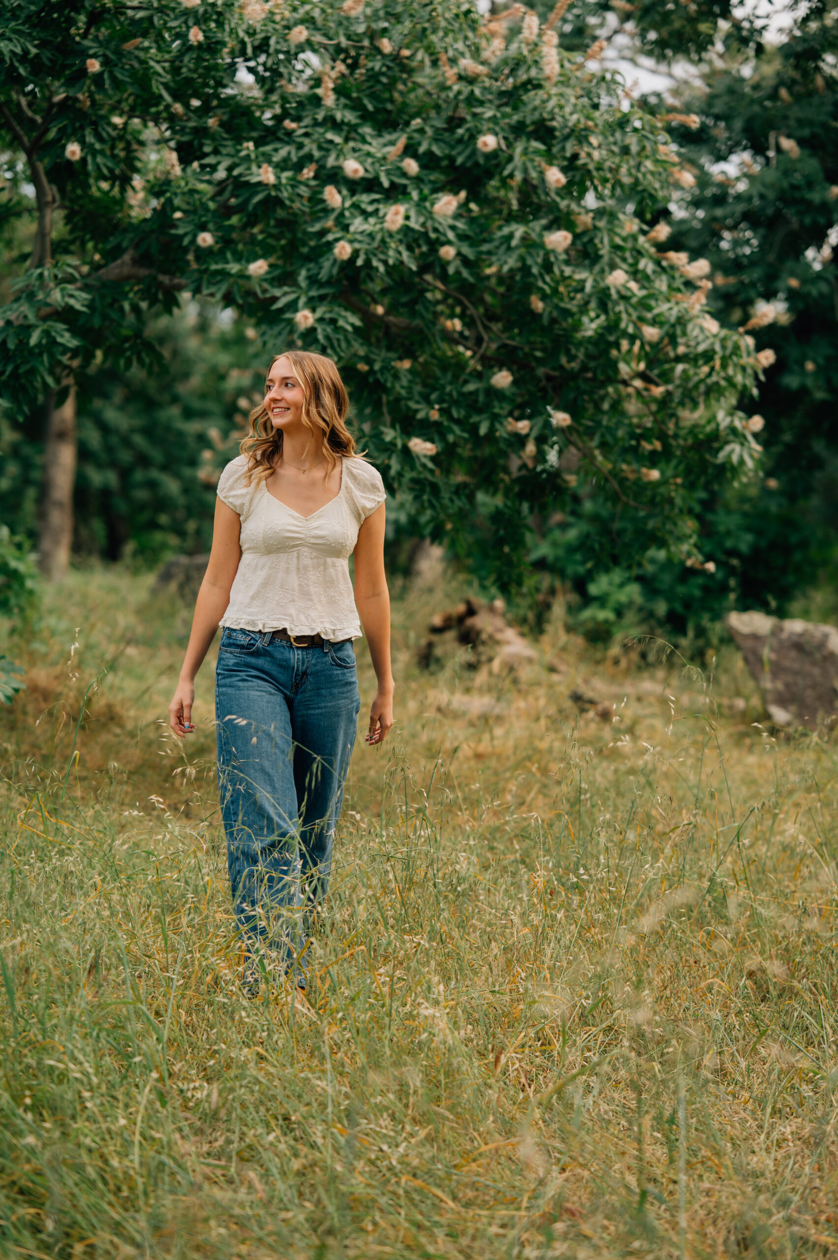 Senior girl standing in tall golden grass at Griffith Quarry Park in Penryn during a Northern California senior session.