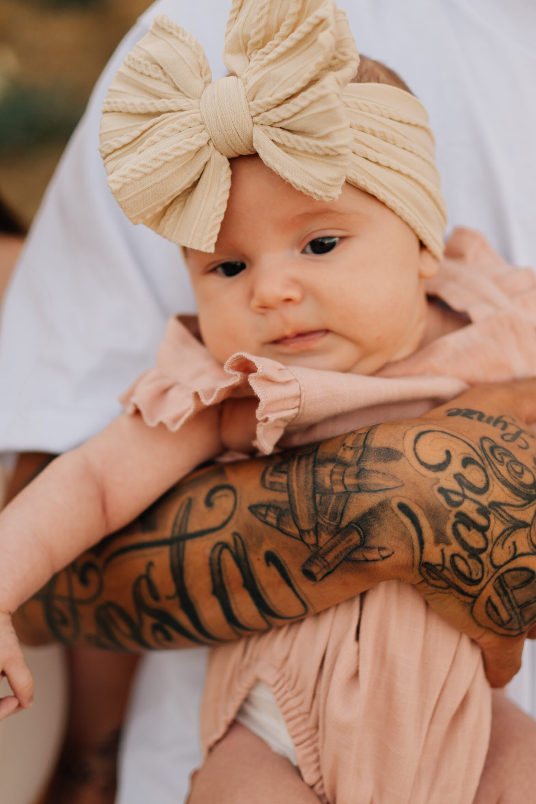 Baby girl in her father's arm at an extended family session in Oak Grove Parkin Ripon