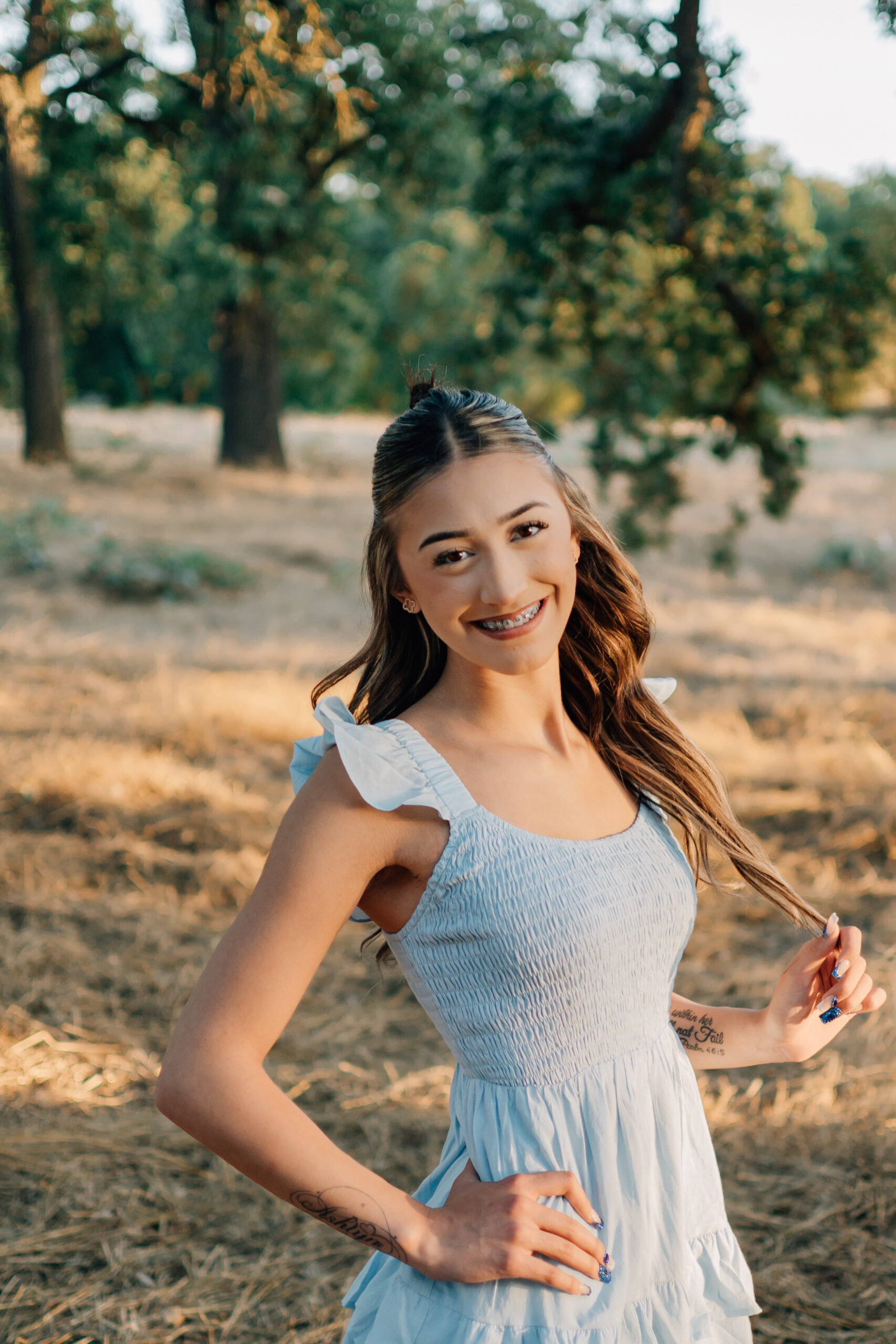 Graduating Senior girl posing for a portrait in Oak Grove Park in Ripon.