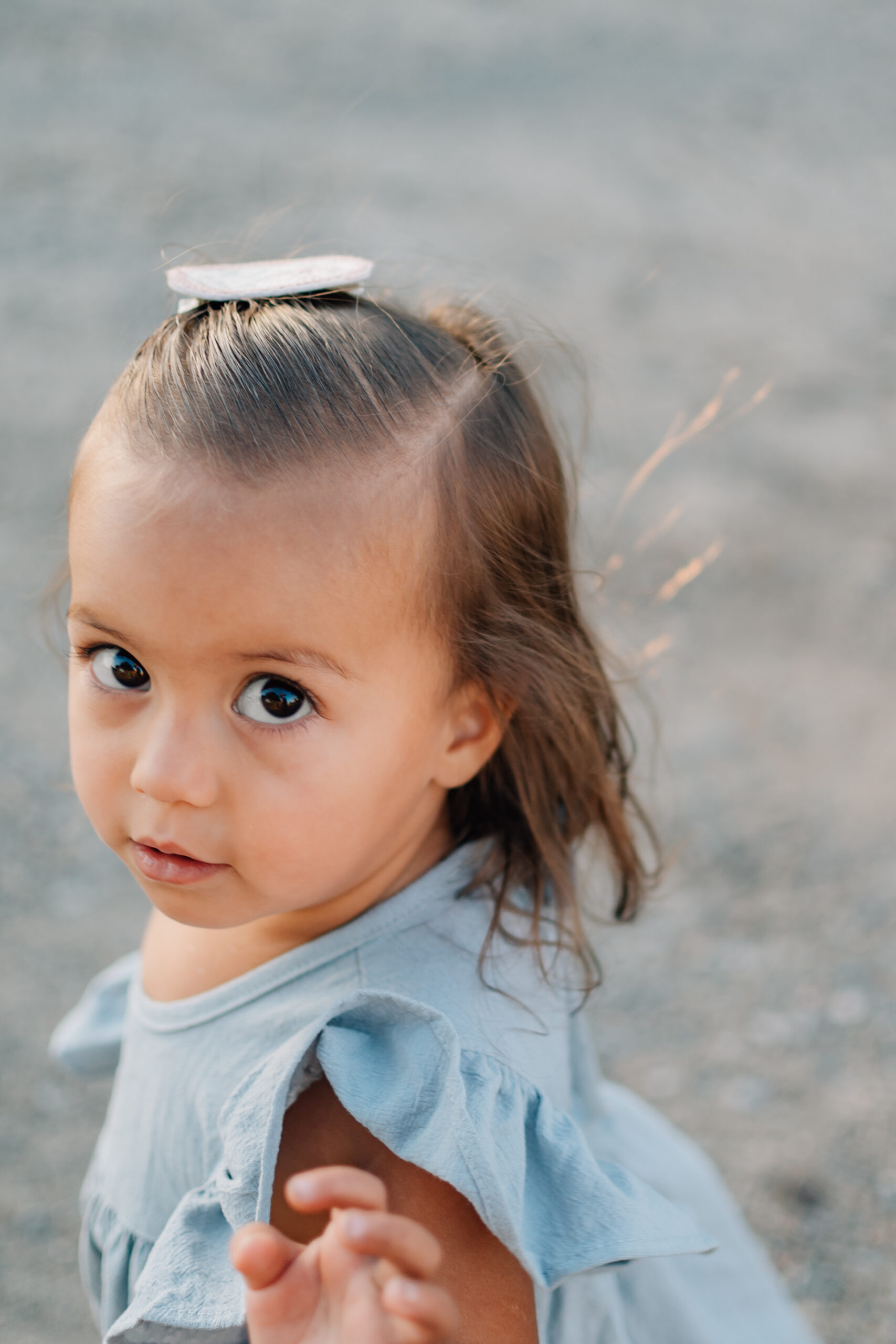 Little girl waving hi in a candid shot at Oak Grove Park in Ripon.