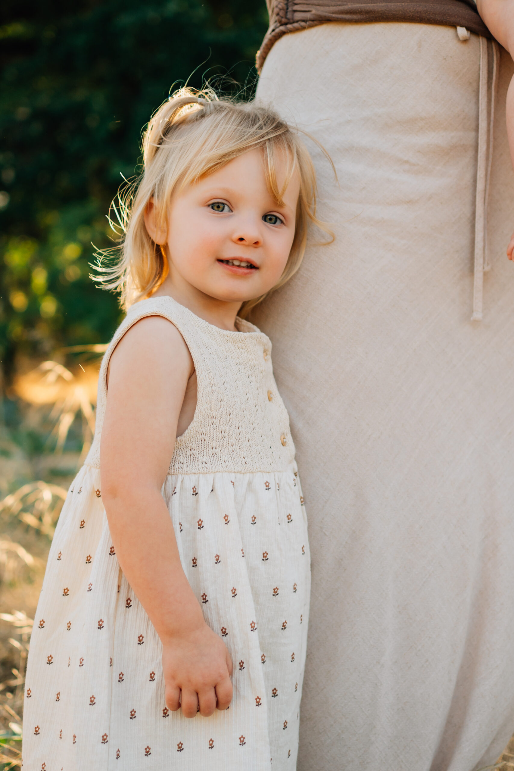 Young girl smiling at the camera during a family photo session at Oak Grove Park in Ripon.
